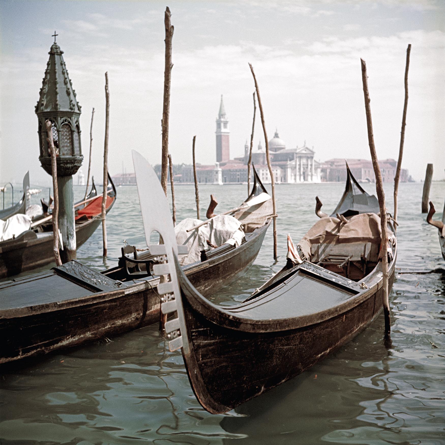 Gondolas moored in Venice, 1957. In the background is the Church of San Giorgio Maggiore, on San Giorgio Maggiore island.

Captured with the exquisite clarity and charm that epitomizes Slim Aarons's work, this 1957 photograph, "Gondolas moored in