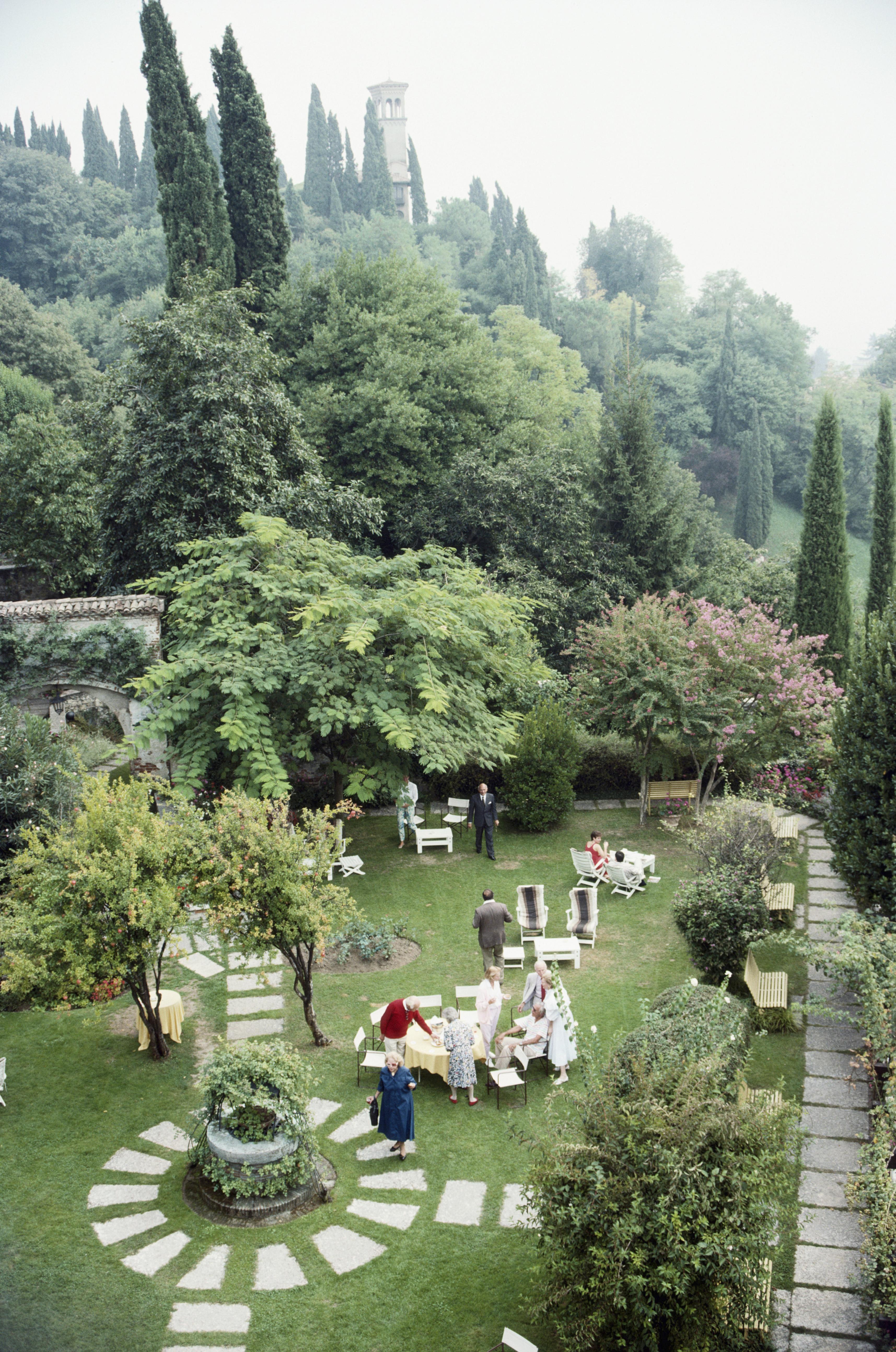 Slim Aarons
Villa Cipriani
1988
C print
Estate stamped and hand numbered edition of 150 with certificate of authenticity from the estate. 

Aerial view of guests in the gardens of the Villa Cipriani in Asolo, Italy, in September 1988. (Photo by Slim