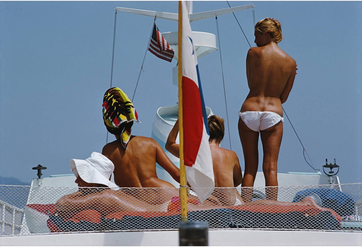 Corps bronzés sur le pont du yacht de Dino Pecci Blunt à Marbella, Espagne, 1967.

Un groupe de jeunes femmes bronzées capturées de dos est vu en train de profiter du chaud soleil espagnol à bord d'un yacht dans le glamour port espagnol. 

Slim