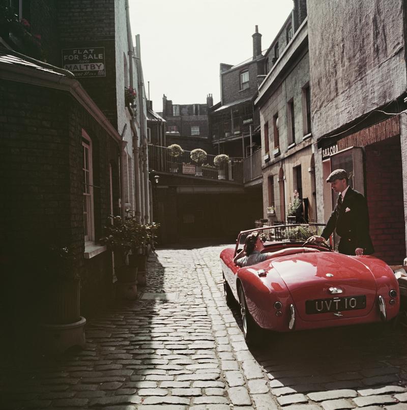 Sports Car Couple 

John Bryant with his AC sports car in Kinnerton Place, London SW1. His passenger is Margaret McAulay. Circa 1955.

Paper size 50 x 50 / 127 x 127 cm
 
Estate Stamped Collection Edition to 150 

Photo by Slim Aarons

Printed in