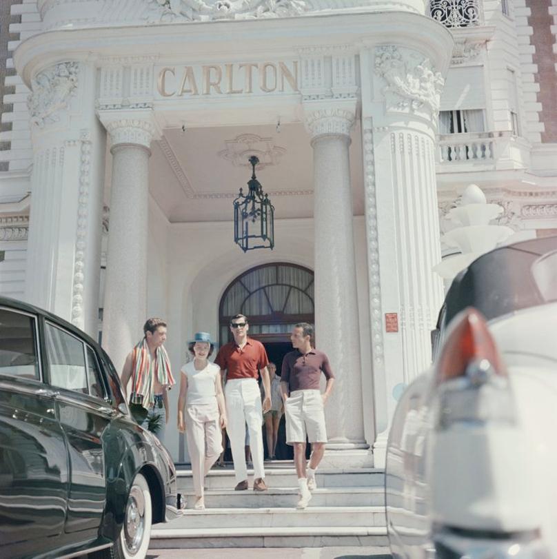 Staying At The Carlton 
1958
by Slim Aarons

Slim Aarons Limited Estate Edition

Guests at the entrance to the Carlton Hotel, Cannes, France, 1958.

unframed
c type print
printed 2023
16×16 inches - paper size


Limited to 150 prints only –