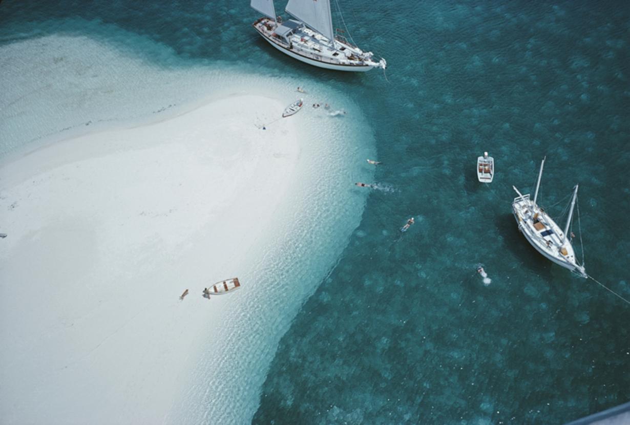 Stocking Island, Bahamas 
1964
by Slim Aarons

Slim Aarons Limited Estate Edition

A high angle view of people swimming next to the ketch ‘Traveler II’ , Stocking Island, Bahamas, 1964.

unframed
c type print
printed 2023
20 x 24"  - paper