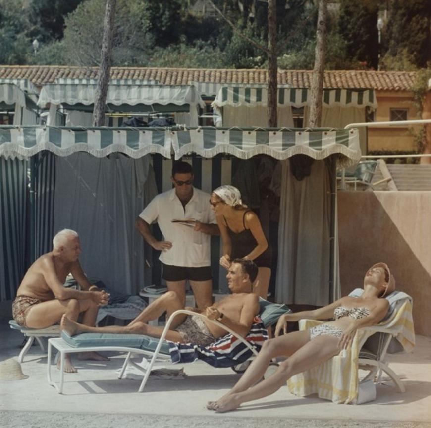 Summer In Monaco 
1957
by Slim Aarons

Slim Aarons Limited Estate Edition

1957: Film director Howard Hawks (1896 – 1977) and his wife Dee spend a summer day by the pool in Monaco with producer Charles K Feldman (1904 – 1968) and Feldman’s protegee