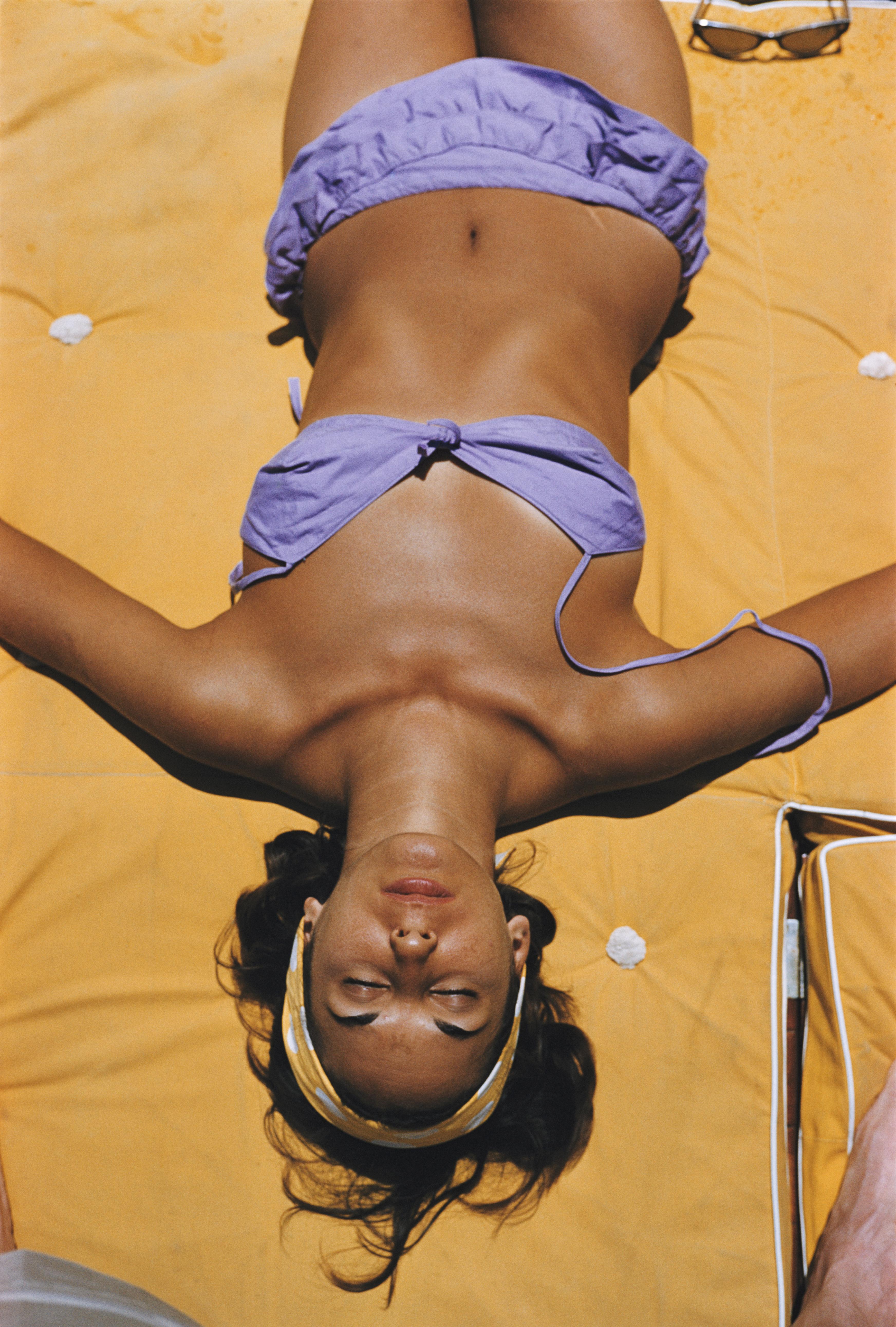 'Sun Worship' 1981 Slim Aarons Limited Estate Edition Print 

Bianca Volpato sunning herself at Capri in a lilac coloured bikini. (Photo by Slim Aarons/Getty Images)

Produced from the original transparency
printed this year
Certificate of