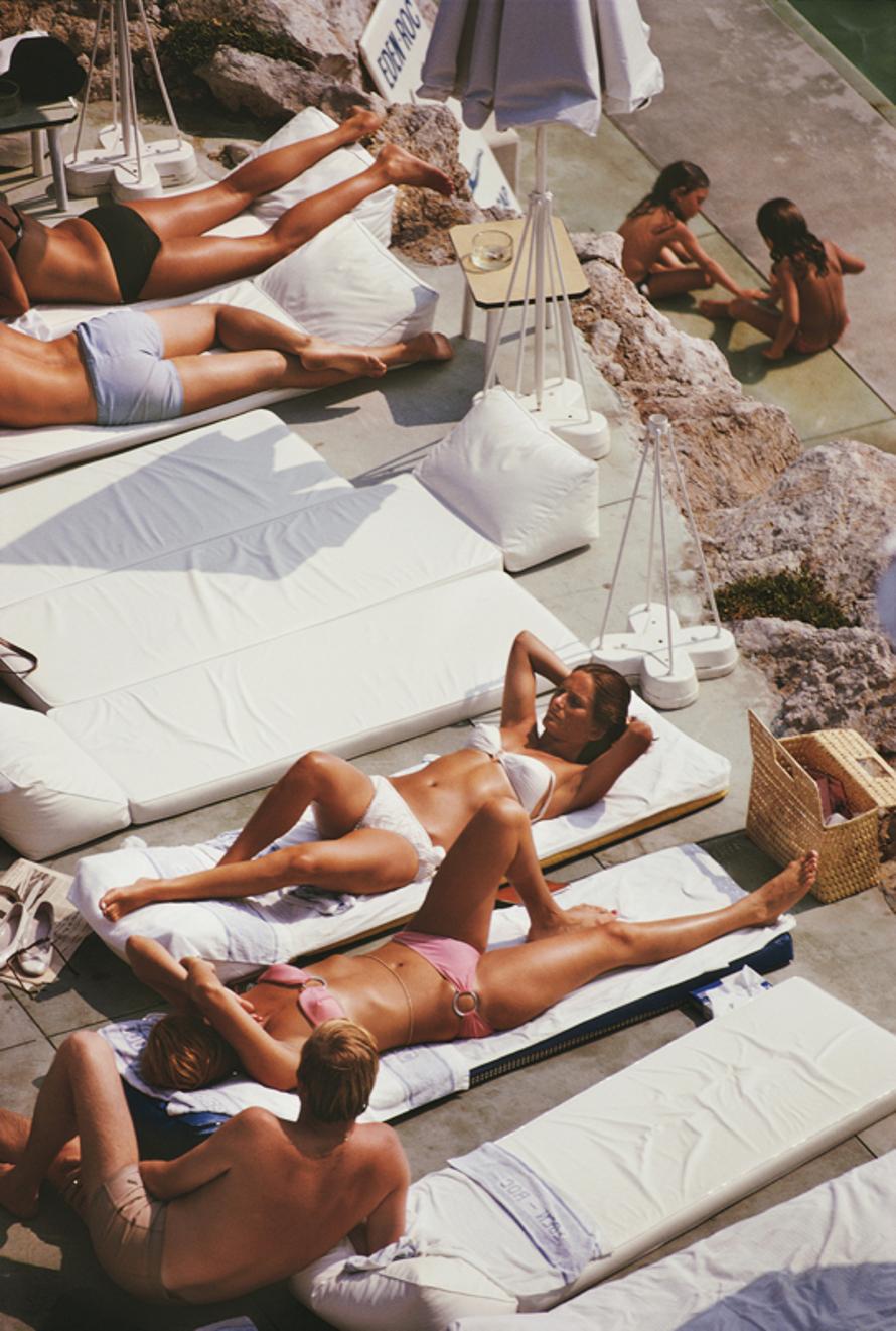 Sunbathers At Eden Roc 
1969
by Slim Aarons

Slim Aarons Limited Estate Edition


Sunbathers at the Hotel du Cap Eden-Roc, Antibes, France, August 1969.

unframed
c type print
printed 2023
20 × 16 inches - paper size


Limited to 150 prints only –