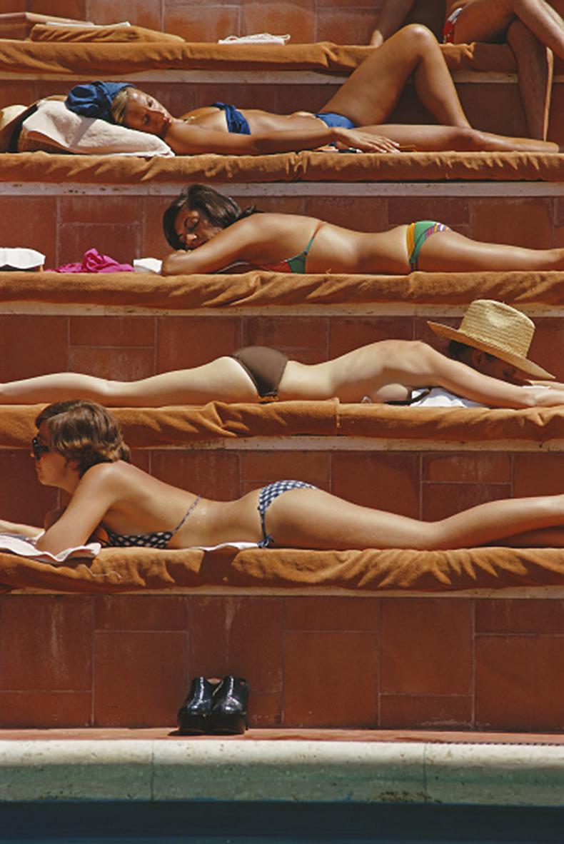 Andros Island (1957) Limited Estate Stamped   

(Photo By Slim Aarons) 

Sunbathers by a swimming pool at the Hotel Punta Tragara on the island of Capri, Italy, August 1974. 

Additional Information: 
Unframed
Paper Size: 20x20'' 
Printed Later