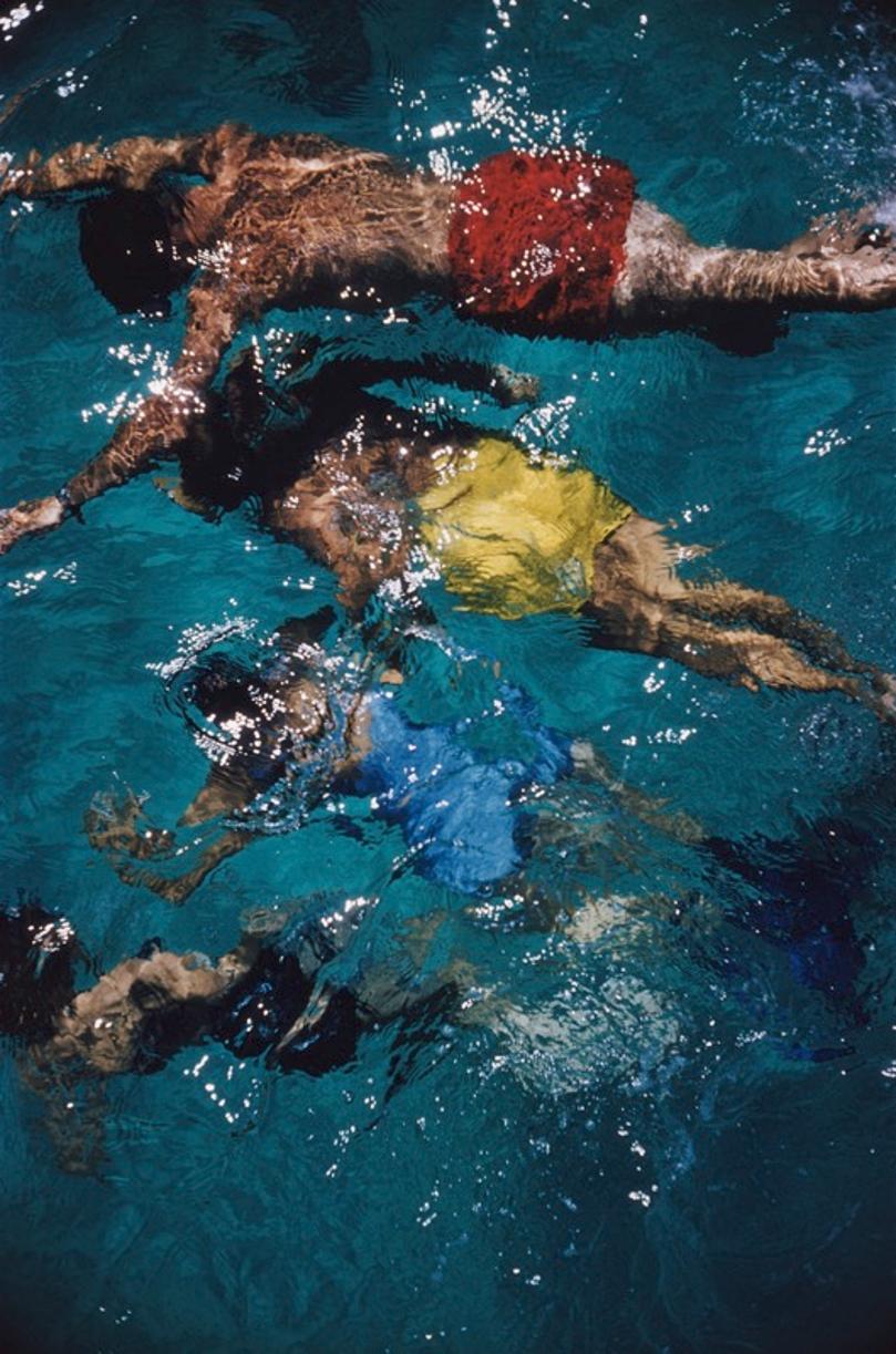 Swimming In The Bahamas 
1959
by Slim Aarons

Slim Aarons Limited Estate Edition

Brightly coloured swimmers in a pool in Nassau on the island of New Providence in the Bahamas, 1959.

unframed
c type print
printed 2023
24 x 20"  - paper