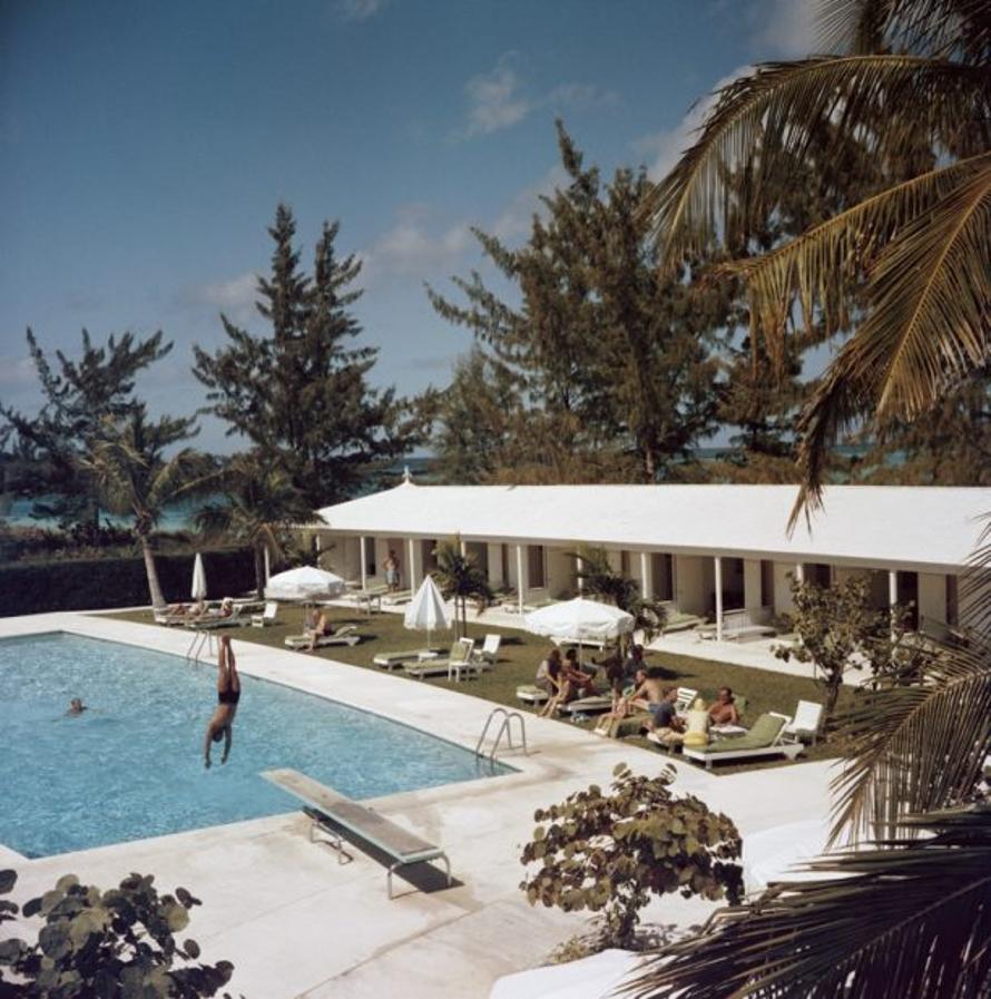 Taking The plunge 
1962
by Slim Aarons

Slim Aarons Limited Estate Edition

A swimming pool at the Lyford Cay Club at Lyford Cay on New Providence Island in the Bahamas, 1962. The club building was designed by American architect Eldredge Snyder.