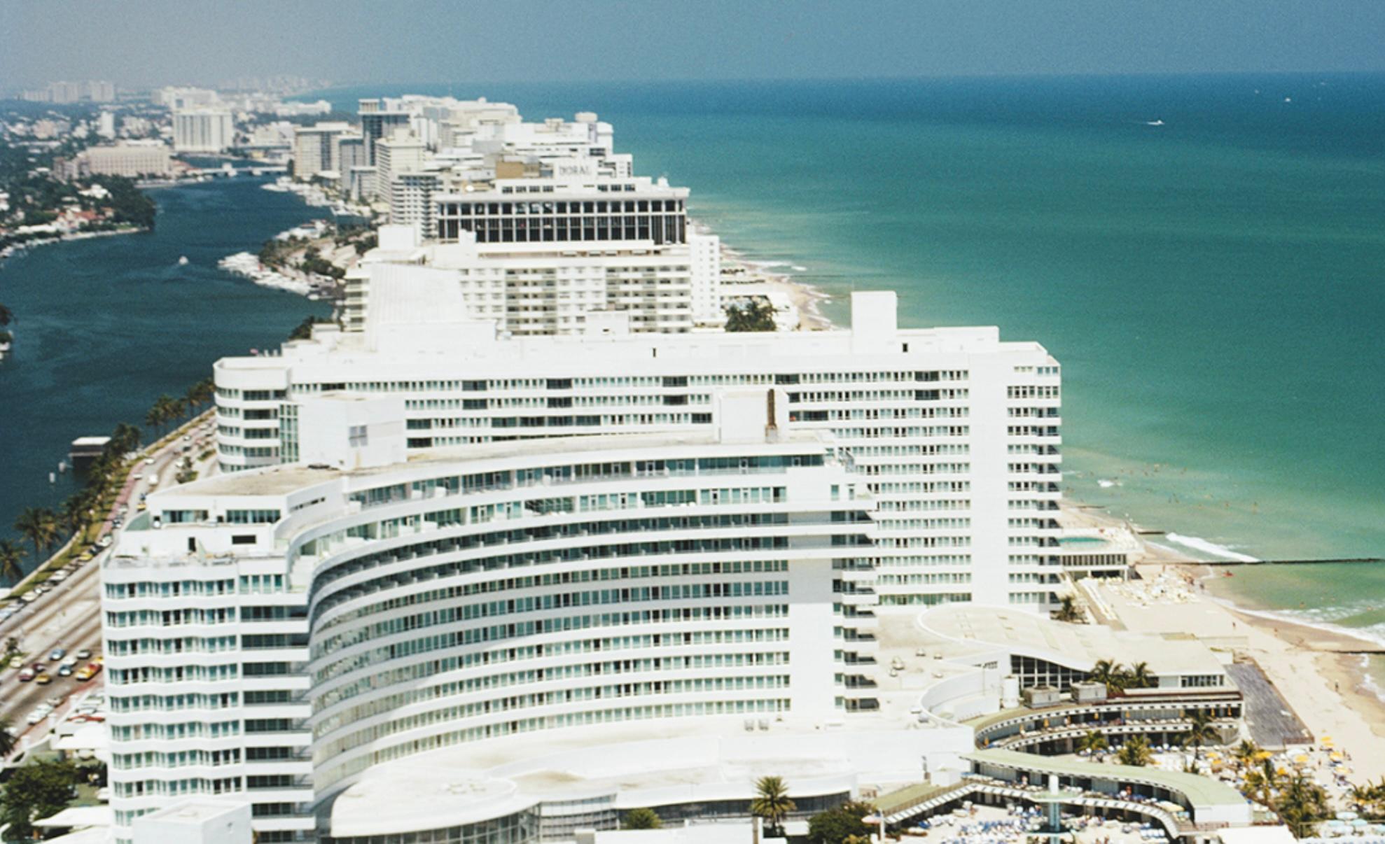 Un hélicoptère transportant des touristes survole l'hôtel Fontainebleau sur la plage de Miami, Floride, avril 1972. 

Slim Aarons
Vue aérienne de Miami Beach
1972
A.C.C. (Imprimé ultérieurement)
Édition de 150 exemplaires numérotés à la main et