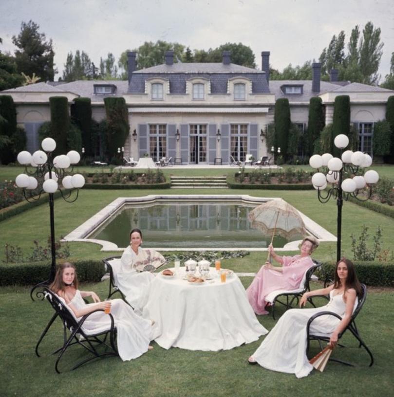 The Romanones 
1976
by Slim Aarons

Slim Aarons Limited Estate Edition

Aline Griffith, Countess of Romanones, and her family sitting in the garden of her home in Spain.

unframed
c type print
printed 2023
20 x 20"  - paper size


Limited to 150