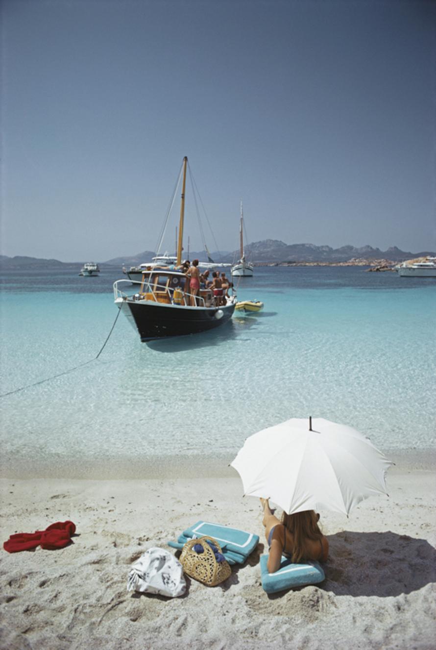 Waiting In The Shade 
1967
by Slim Aarons

Slim Aarons Limited Estate Edition

A woman shelters under a parasol on a beach on the Costa Smeralda, Sardinia, 1967

unframed
c type print
printed 2023
20 × 16 inches - paper size


Limited to 150 prints