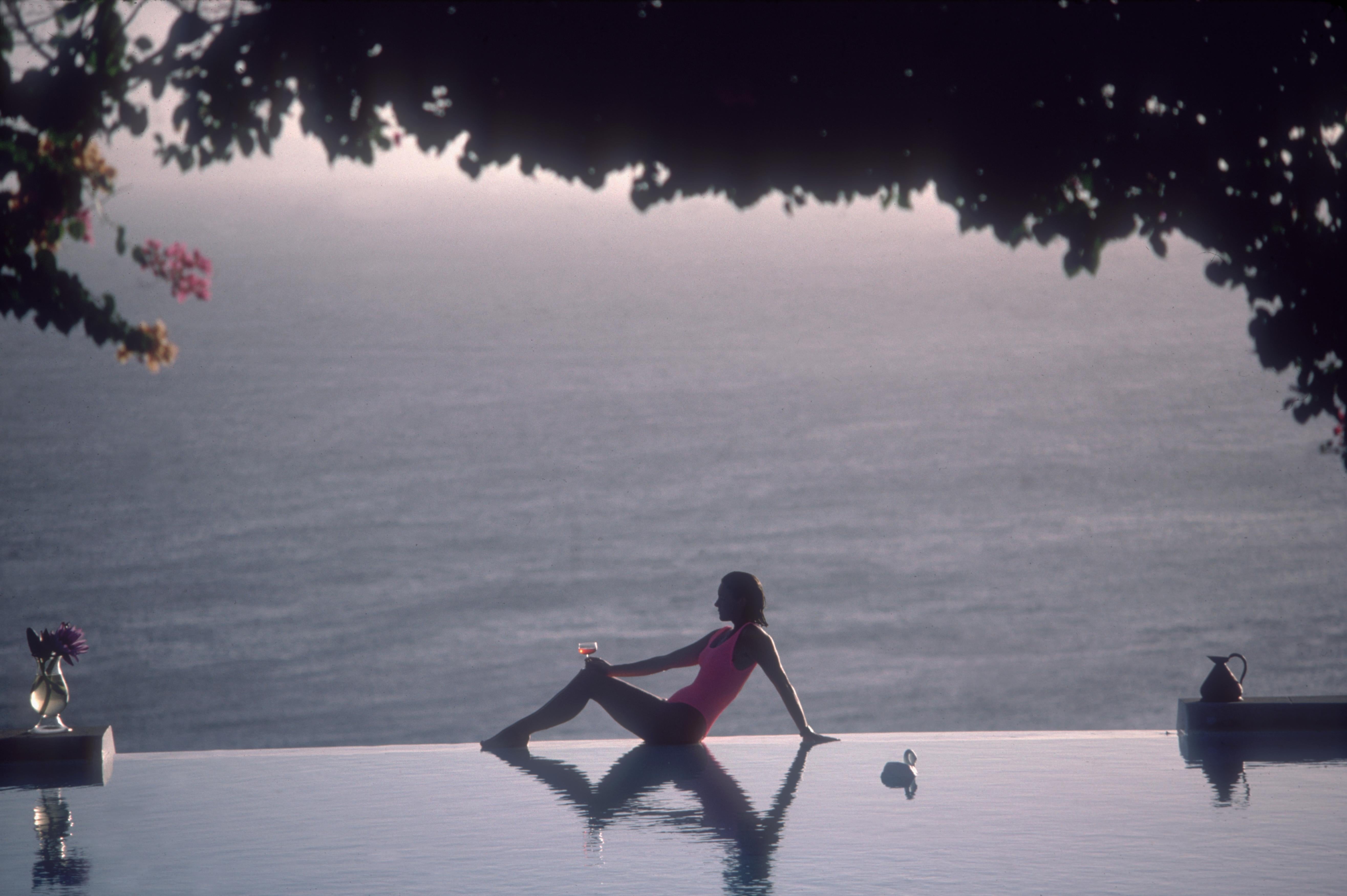 'Water Babe' 1989 Slim Aarons Limited Estate Edition Print 

'Town & Country' writer Meg O'Neil relaxes by the pool on the island of Mustique, in the Grenadines, February 1989.
(Photo by Slim Aarons/Getty Images)

Produced from the original