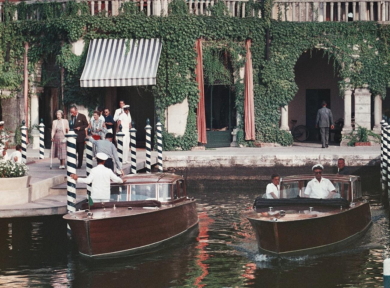Westin Excelsior, Lido in Venice, 1957 - Venetian Gondolas in Canals in Italy - American Modern Photograph by Slim Aarons