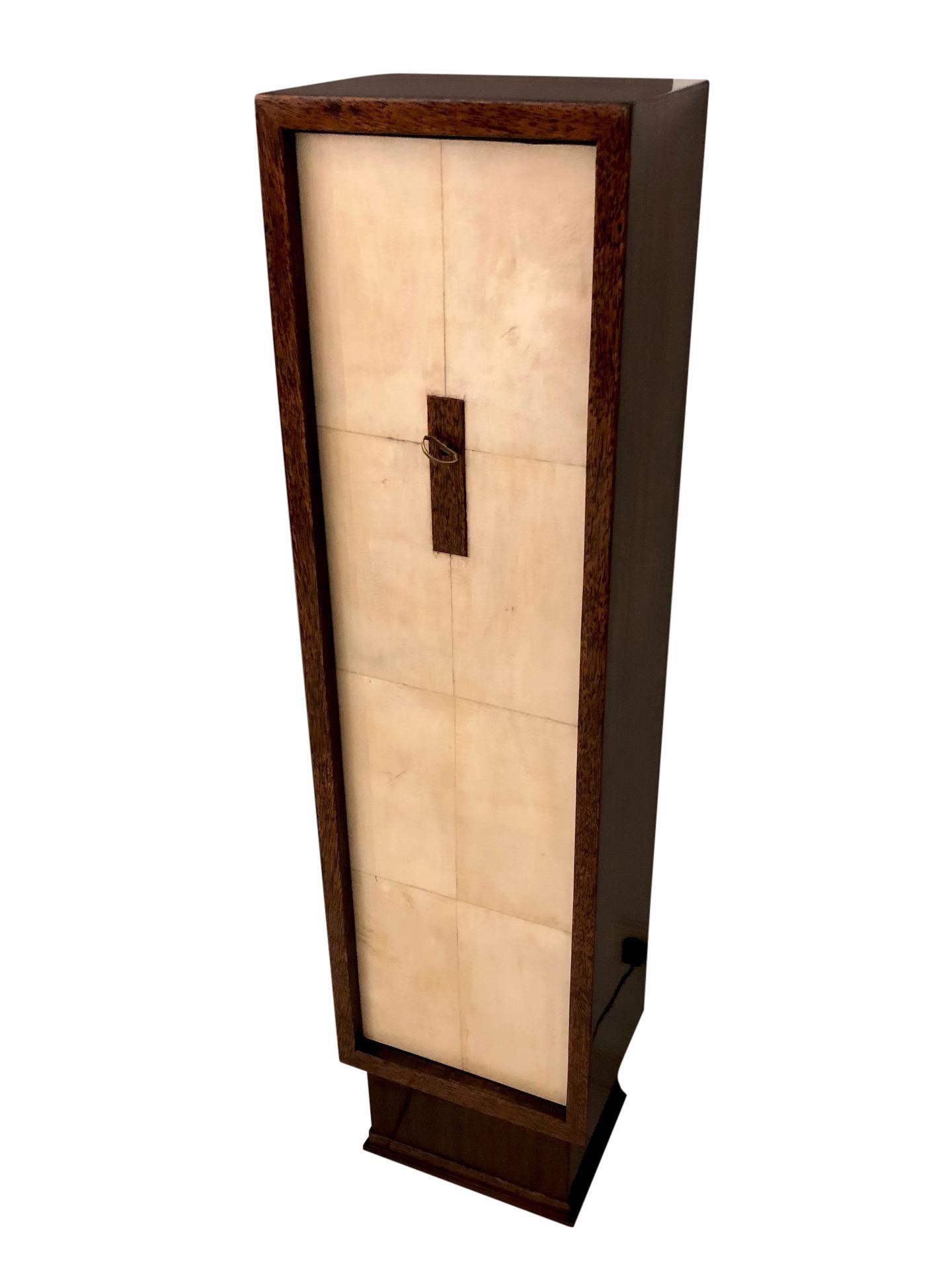 Slim Art Deco cabinet in palm wood 
Front door with parchment surface 
Key lock in the middle of the door 
attributed to Maison Dominique.

High quality restoration 
Shellac hand polish 

Original French Art Deco, 1930s.