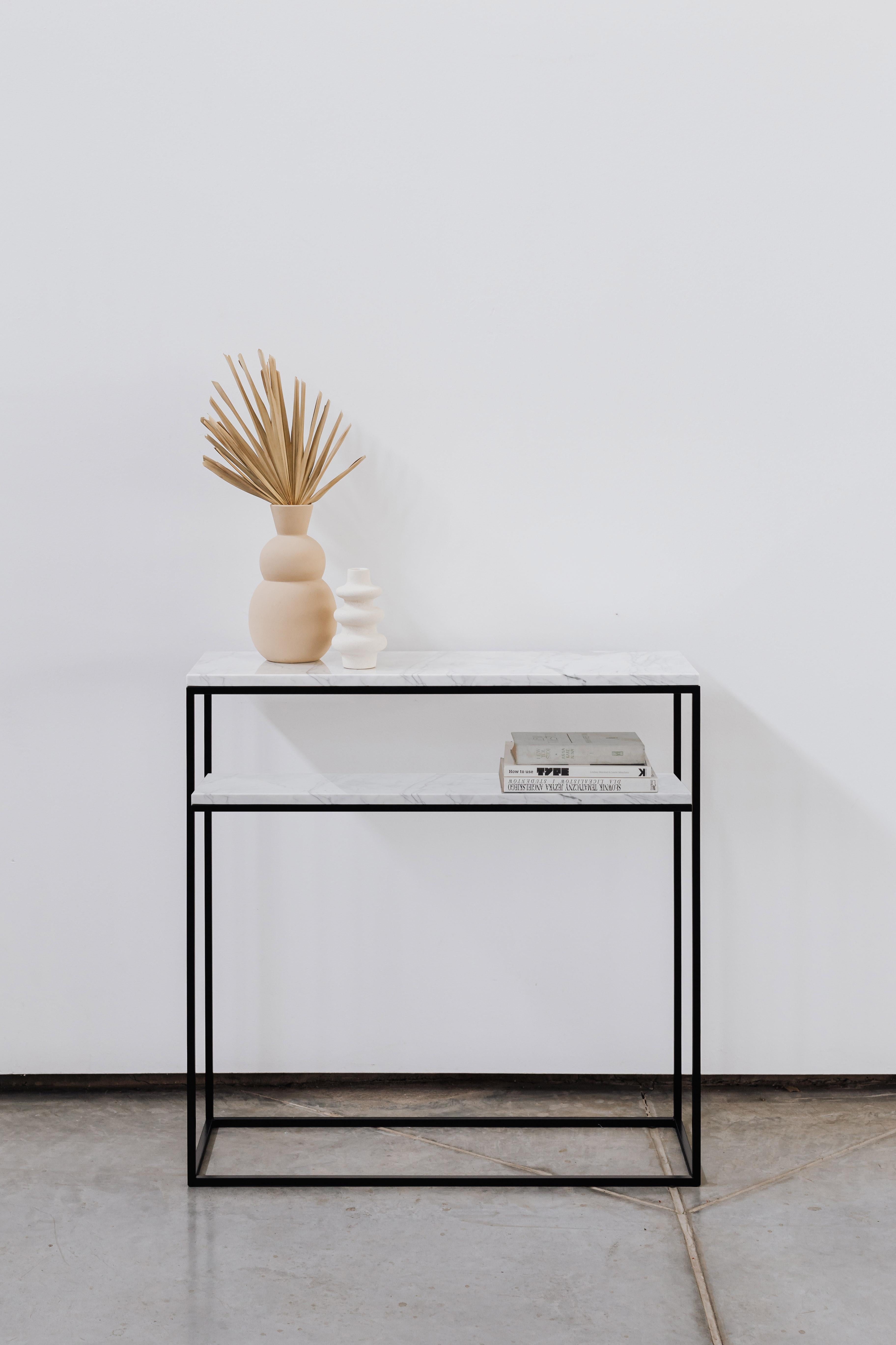 SLIM DUO is the classic accessory console with two marble tops. It can be made from the classic light-coloured Carrara marble or the black Nero Marquina marble. Two tops provide plenty of space to store anything you need to keep on hand, and they