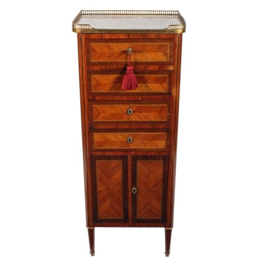 A slim late 19th to early 20th century French kingwood veneered cabinet.

The cabinet has a variegated marble top with a pierced brass gallery to three sides.

The cabinet has four oak lined drawers with kingwood quarter veneered fronts that are