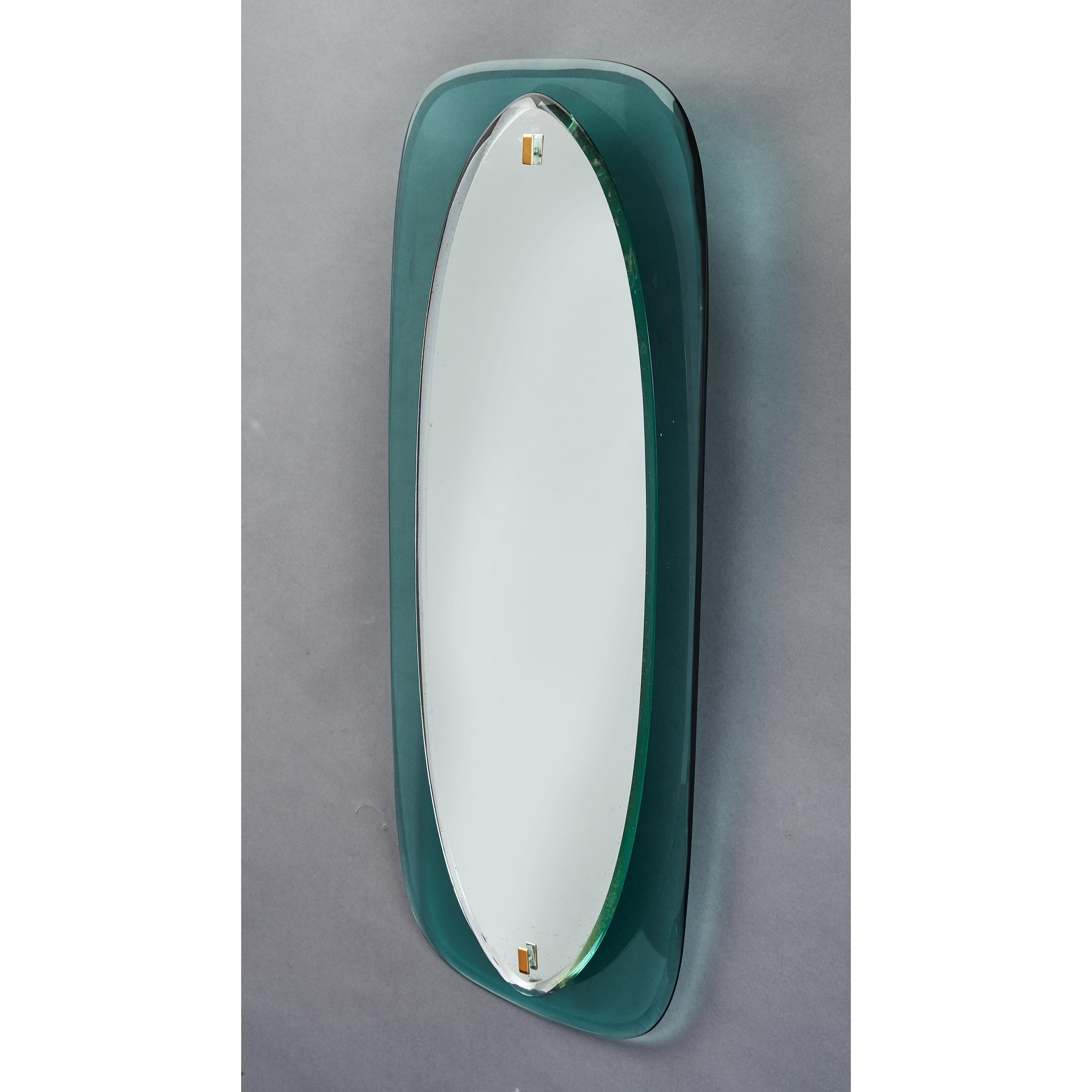 Italy 1960's
Elegantly narrow beveled oval mirror raised on a bowed colored glass frame, with brass mounts, in the manner of Fontana Arte
Measures: 34.5 H x 13.5 W x 2 D
We have another mirror of the same model in a different colored glass. See