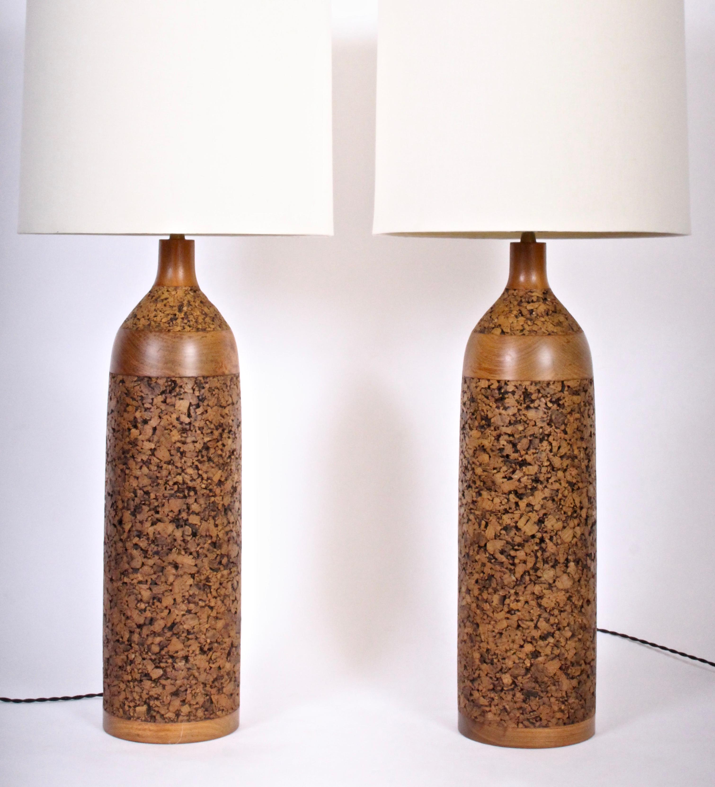 Slender American Mid Century three foot high pair of Walnut and Cork Table Lamps, 1960's. Featuring contoured Cork bottle forms with turned Walnut details. Small footprint. Shades shown for display only (11H x 13.5 D top x 14 D bottom). 36 H with