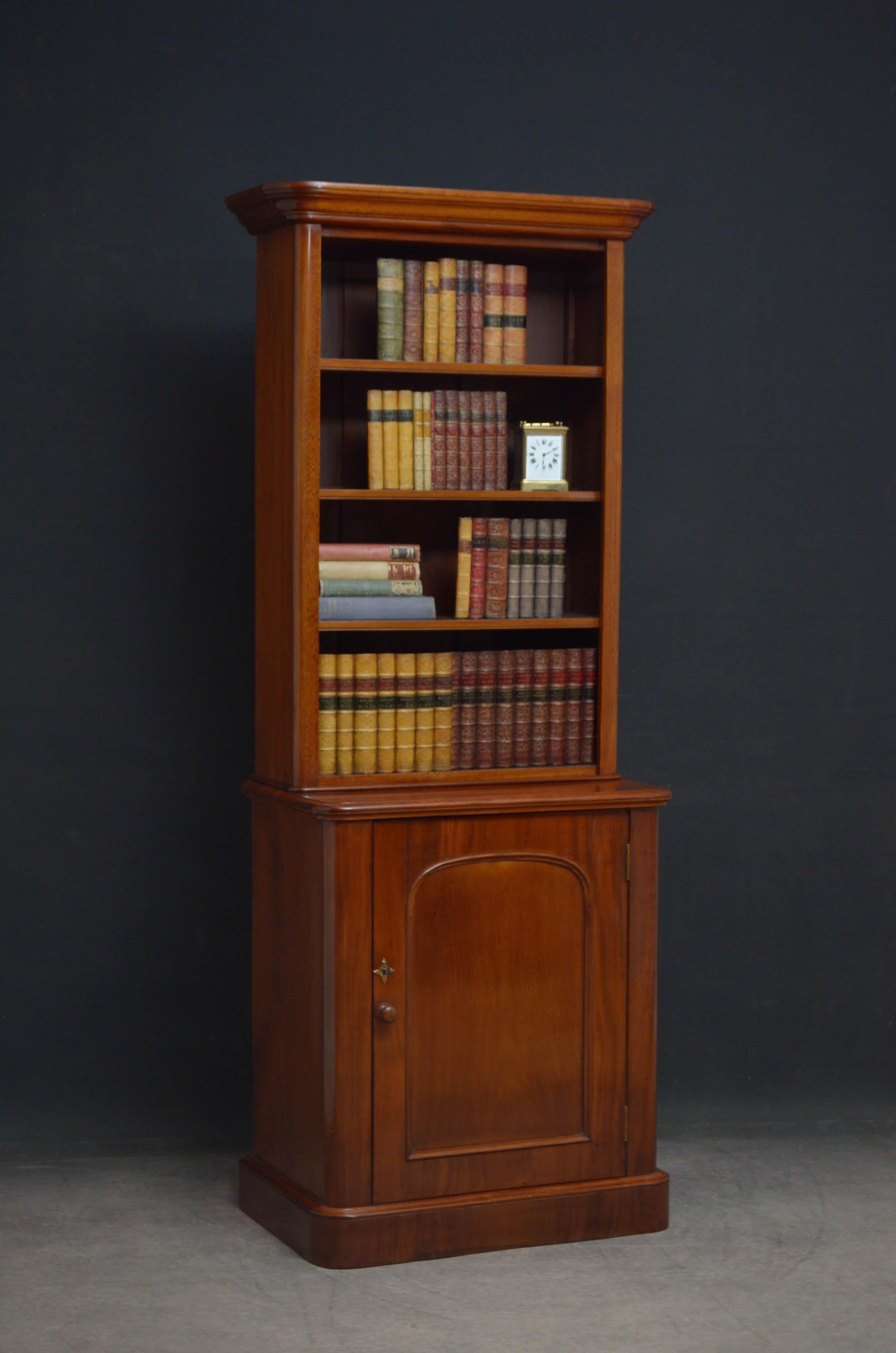 Sn4856, slim Victorian bookcase in mahogany, having cavetto cornice with rounded corners above 3 height adjustable shelves and projecting base with arched and [paneled cupboard door fitted with original working lock, key and turned know, enclosing a