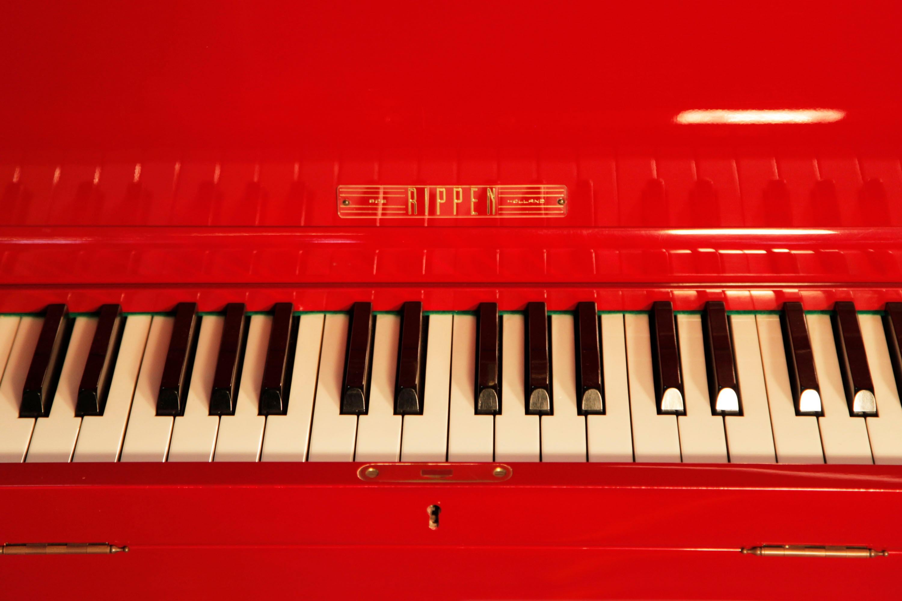 A 1959, Rippen grand piano with a contrasting cherry polyester and painted cream case. The entire cabinet, legs and lyre are made from aluminium. This Rippen piano has a beautiful slimline outline in comparison to other grand pianos. It features a