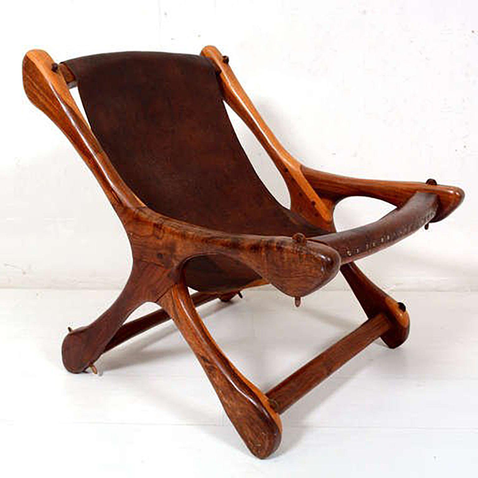 For your consideration a sling chair with sculptural wood frame and old leather sling. Leather attached by nails to the wood frame. 

Stamped: Senal, STA MARIA, MORELIA MEX.

