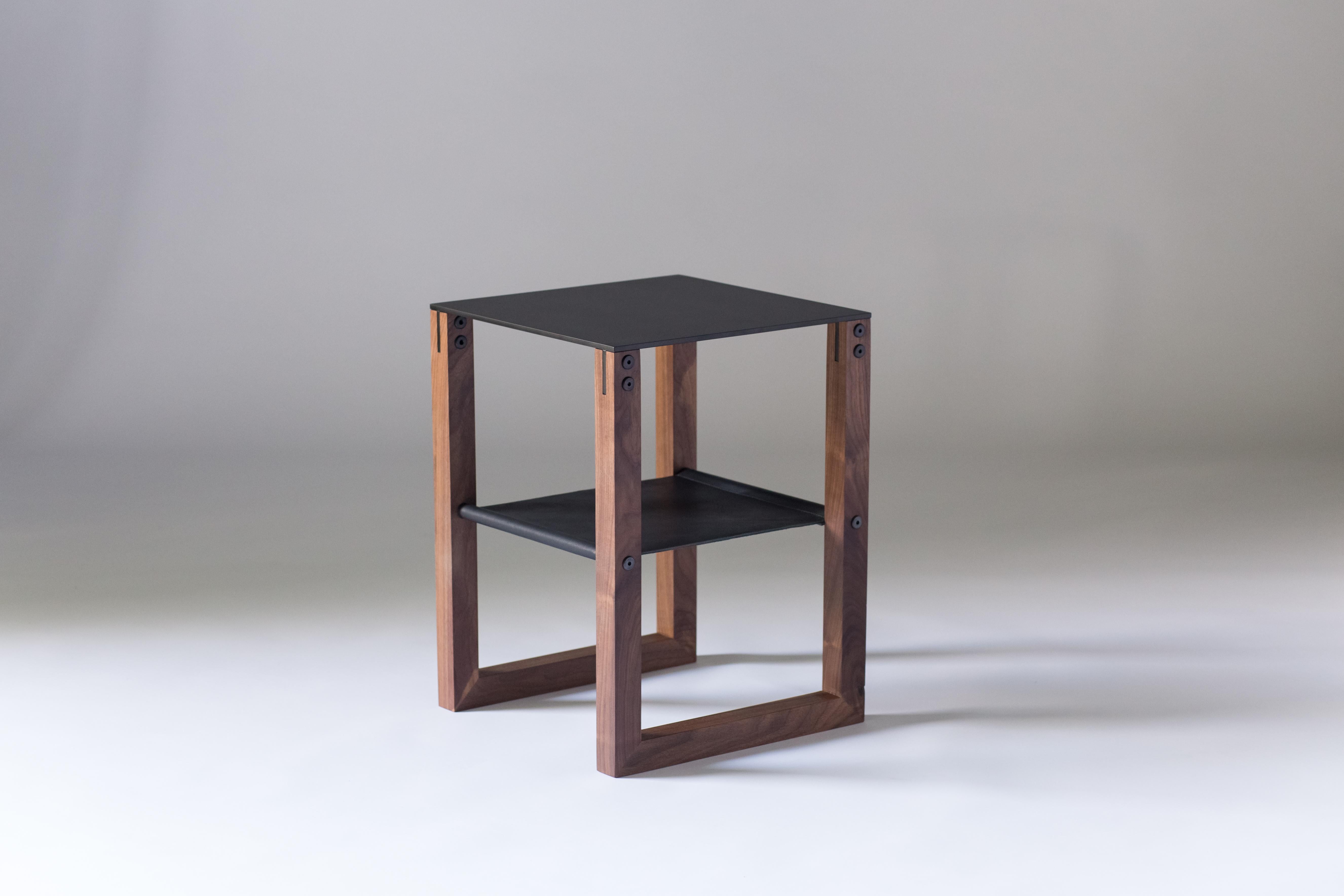The Sling - Modern Aluminum, Leather and Walnut Side Table

 Minimal and elegant form paired with a balanced and thoughtful design. The Sling side table features powder-coated aluminum, blackened hand-stitched leather, and hand finished walnut.