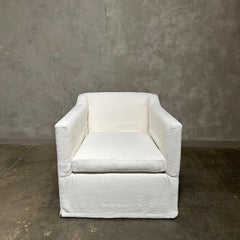 slip cover swivel chair upholstered in white belgian linen