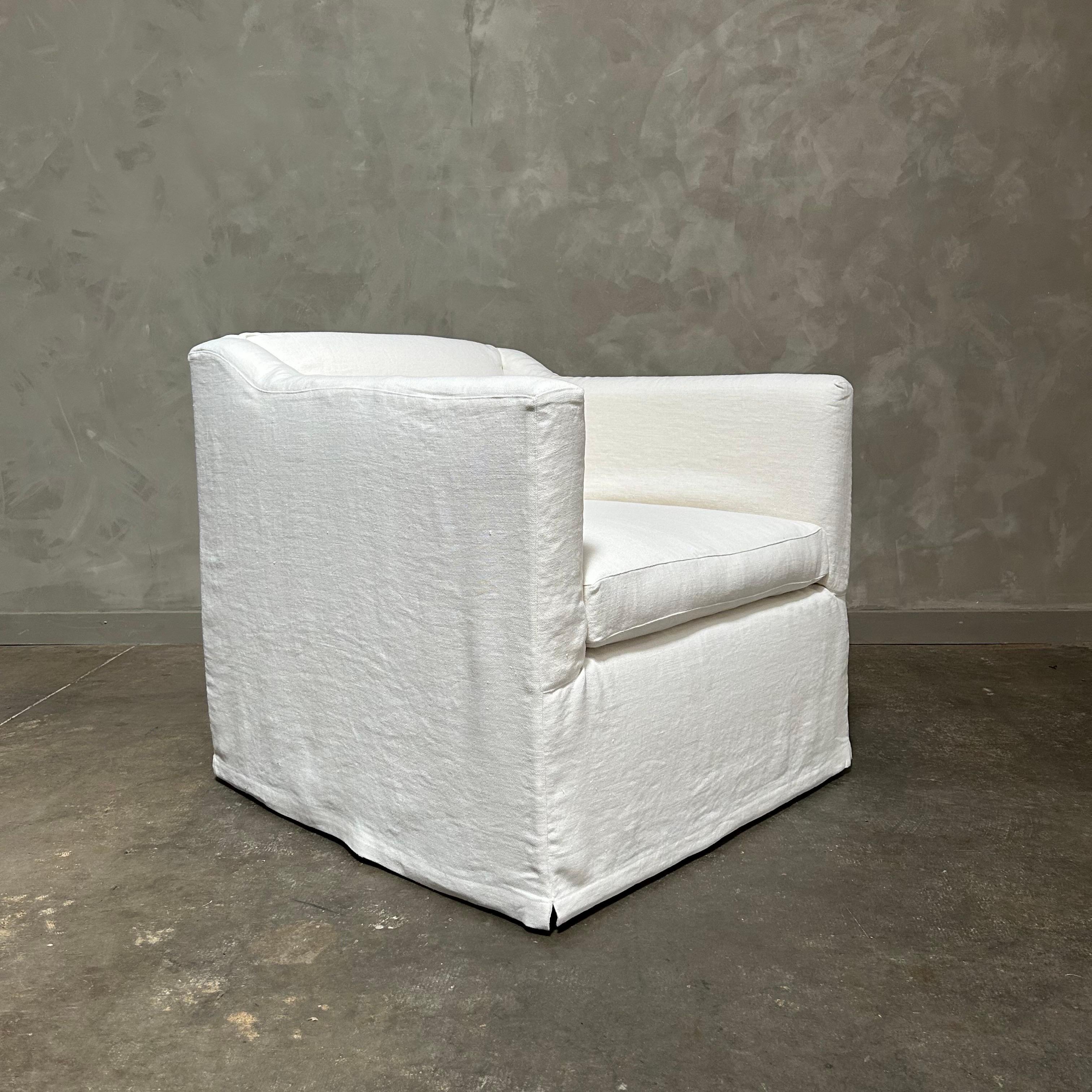 American slip cover swivel chair upholstered in white belgian linen For Sale