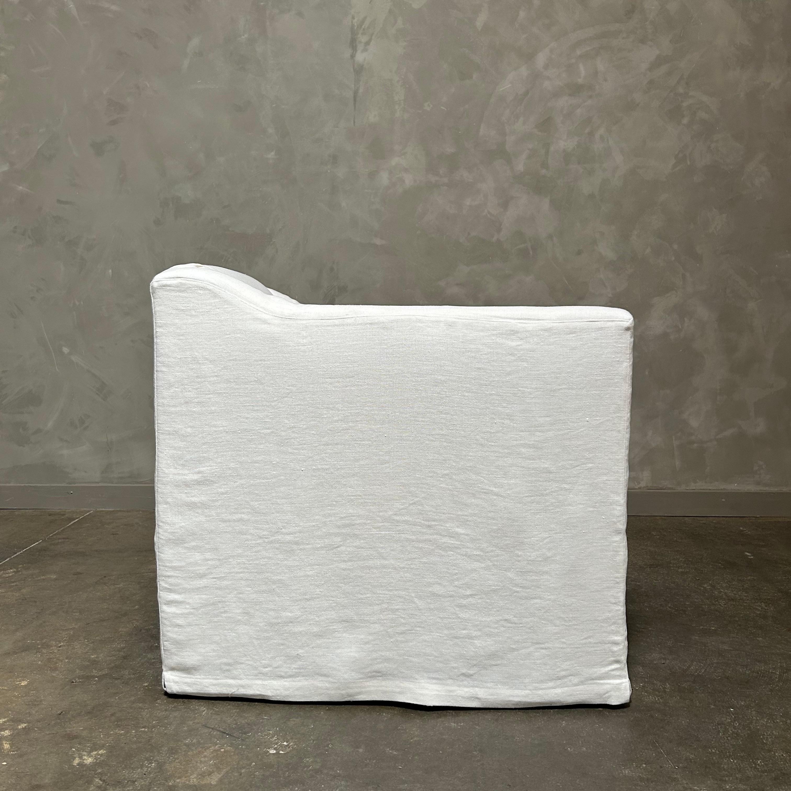 Contemporary slip cover swivel chair upholstered in white belgian linen For Sale