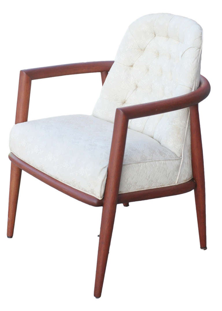A wonderful Robsjohn-Gibbings armchair with carved teak frame and a tufted eggshell white seat for Widdicomb.