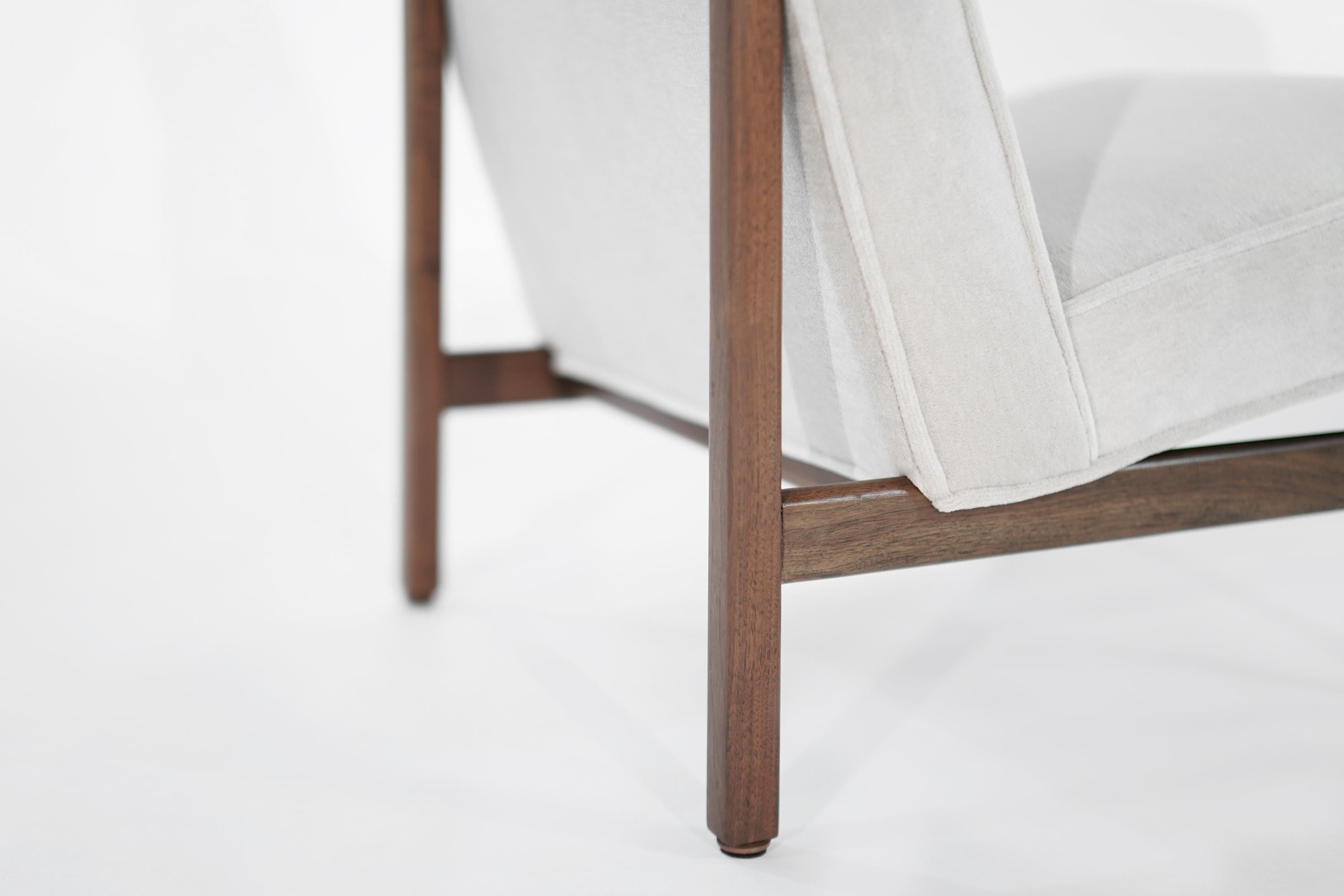 Rarely seen slipper chair designed by Florence Knoll, newly upholstered in Great Plains alpaca velvet by Holly Hunt. Walnut frame fully restored.