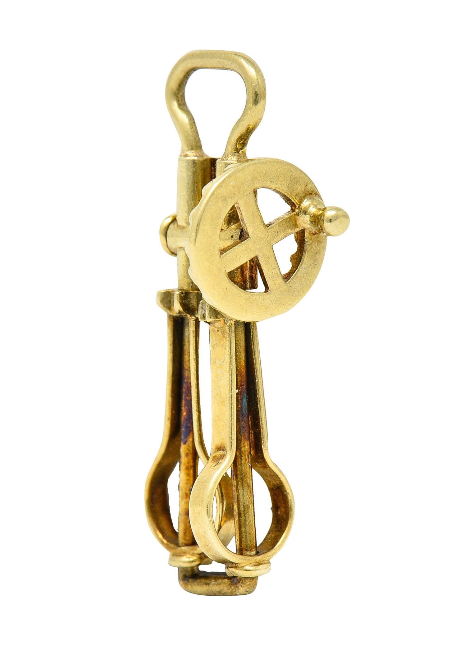 Charm is designed as a vintage style hand mixer

With a functional circular crank that rotates both beaters

Stamped 14K for 14 karat gold

With maker's mark for Sloan & Co.

Circa: 1940s

Measures: 3/8 x 15/16 inch

Total weight: 1.4