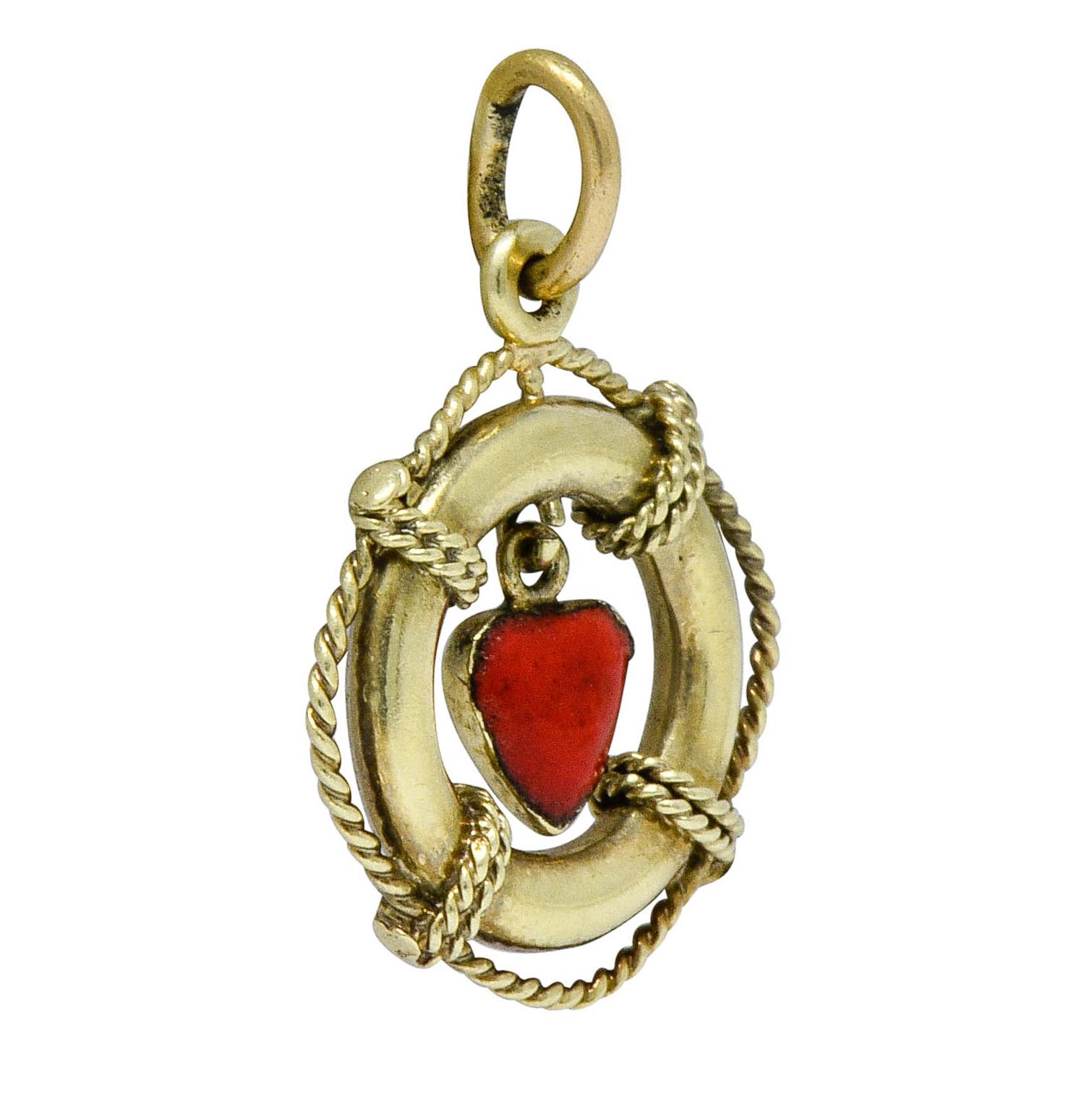 Circular charm is designed as a nautical life preserver with gold twisted rope details

Centering an articulated enamel heart, bright red, and exhibiting minor loss

With maker's mark for Sloan & Co.

Stamped 14K for 14 karat gold

Circa: