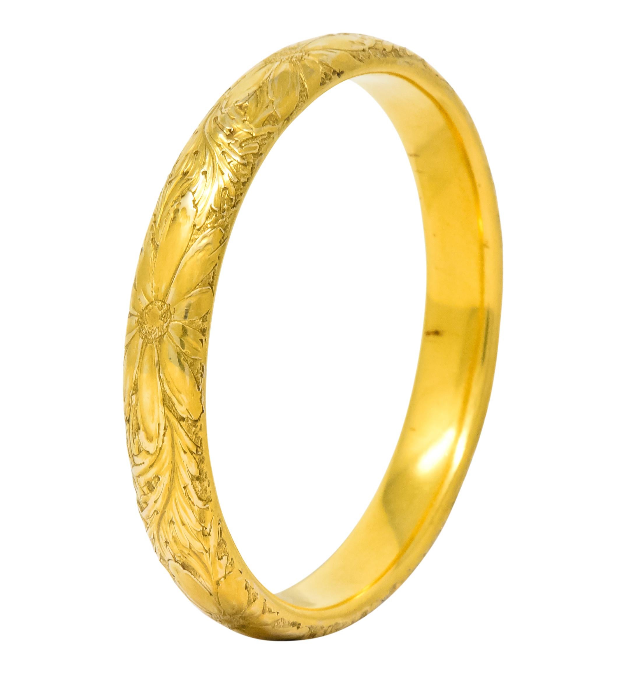 Hollow gold bangle bracelet with hand engraved flower and foliate detail all the way around

With maker's mark for Sloan & Co.

Stamped 14 for 14 karat gold

Inner circumference: 7 1/2 inches

Width: 1/2 inch

Total weight: 17.6 grams

Blossoming.