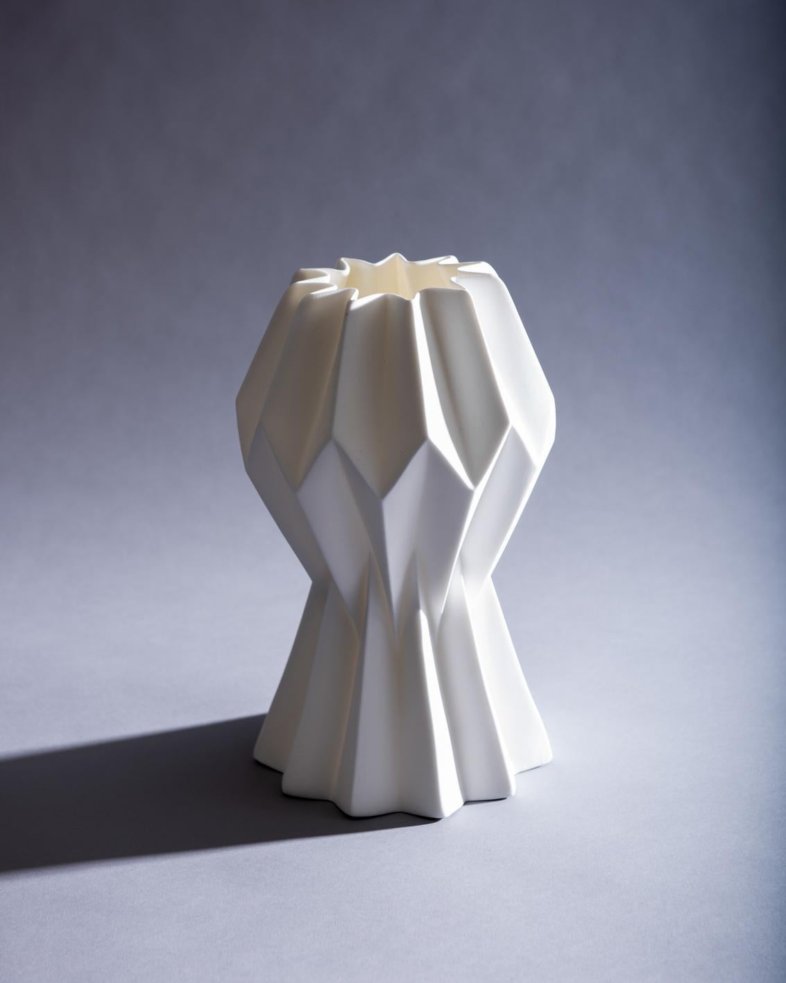Slump vase, no slump variation, capturing ideas of form, structure and failure, the pleated paper form is translated into a fine bone china that is stressed through the excessive heat of the furnace into a poetic collapse. Developed in the studio of