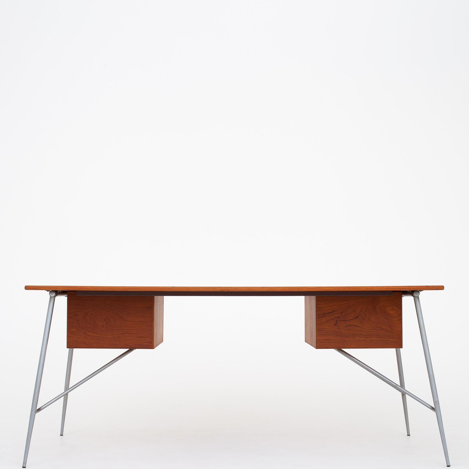 SM 202, desk in teak on steel frame with four drawers. Designed in 1953. Maker Søborg Møbler.