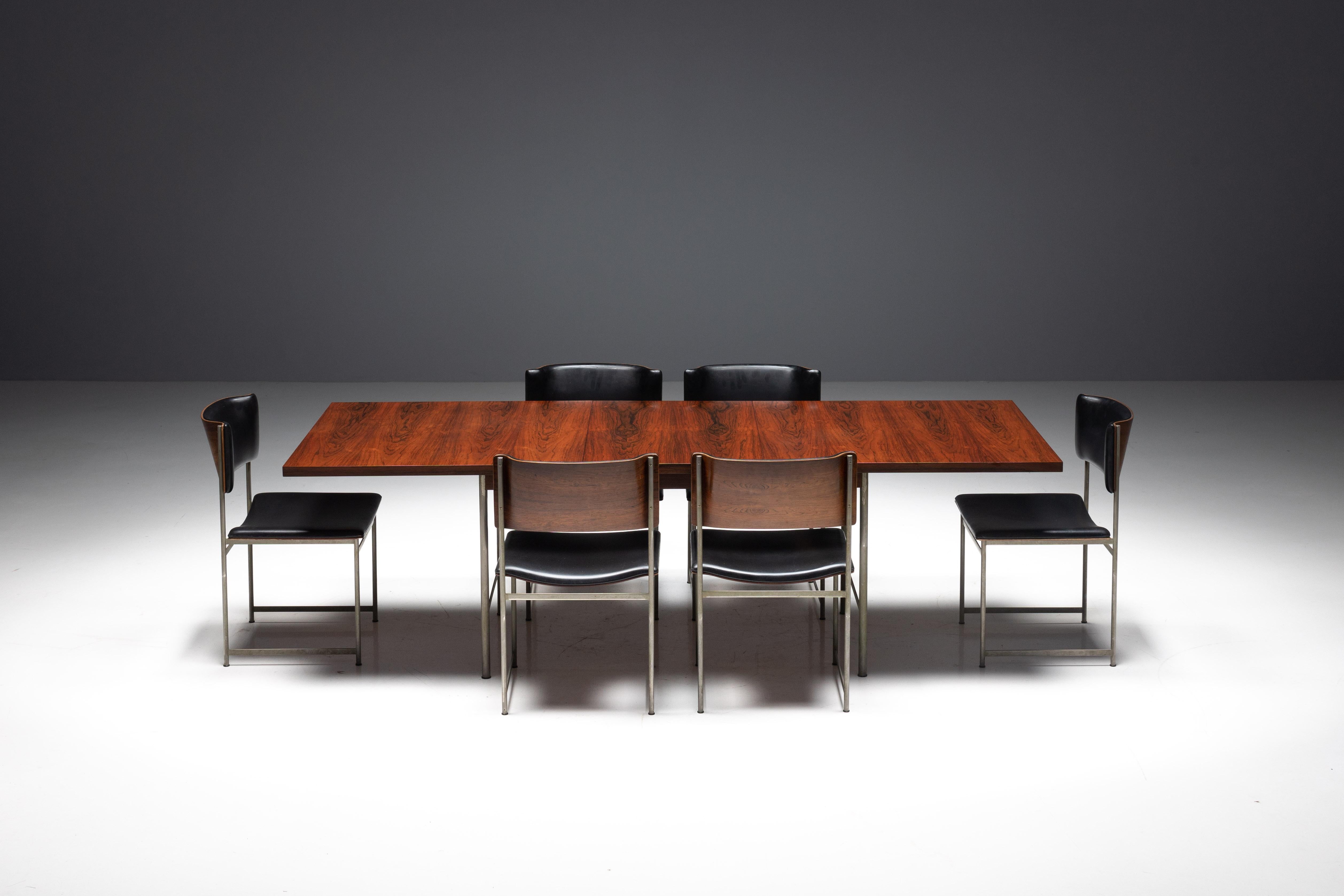 SM08 extendable dining table by Cees Braakman for Pastoe, crafted in the Netherlands during the 1960s. The table features sleek metal legs that provide a sturdy and stylish foundation, complemented by a rosewood veneer tabletop. Imbued with warmth