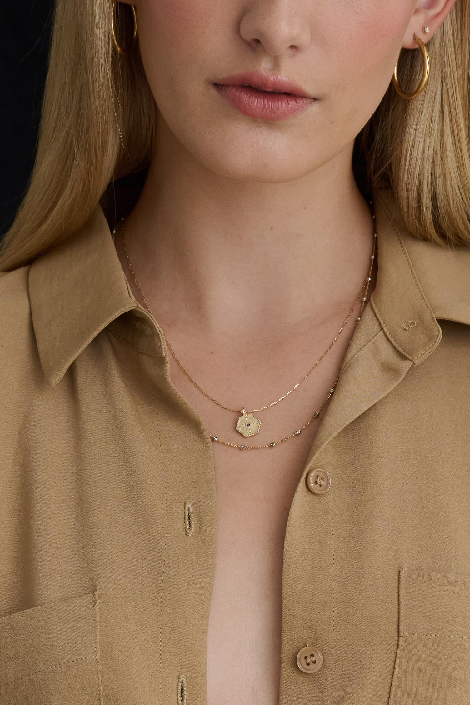 This protection necklace is crafted from 14K gold and set with sapphires and diamonds. Its modern hexagon pendant hangs perfectly from Sparkly Diamond Cut Anchor chain. This luxurious piece is perfect for everyday wear. Pendant Slides off chain so