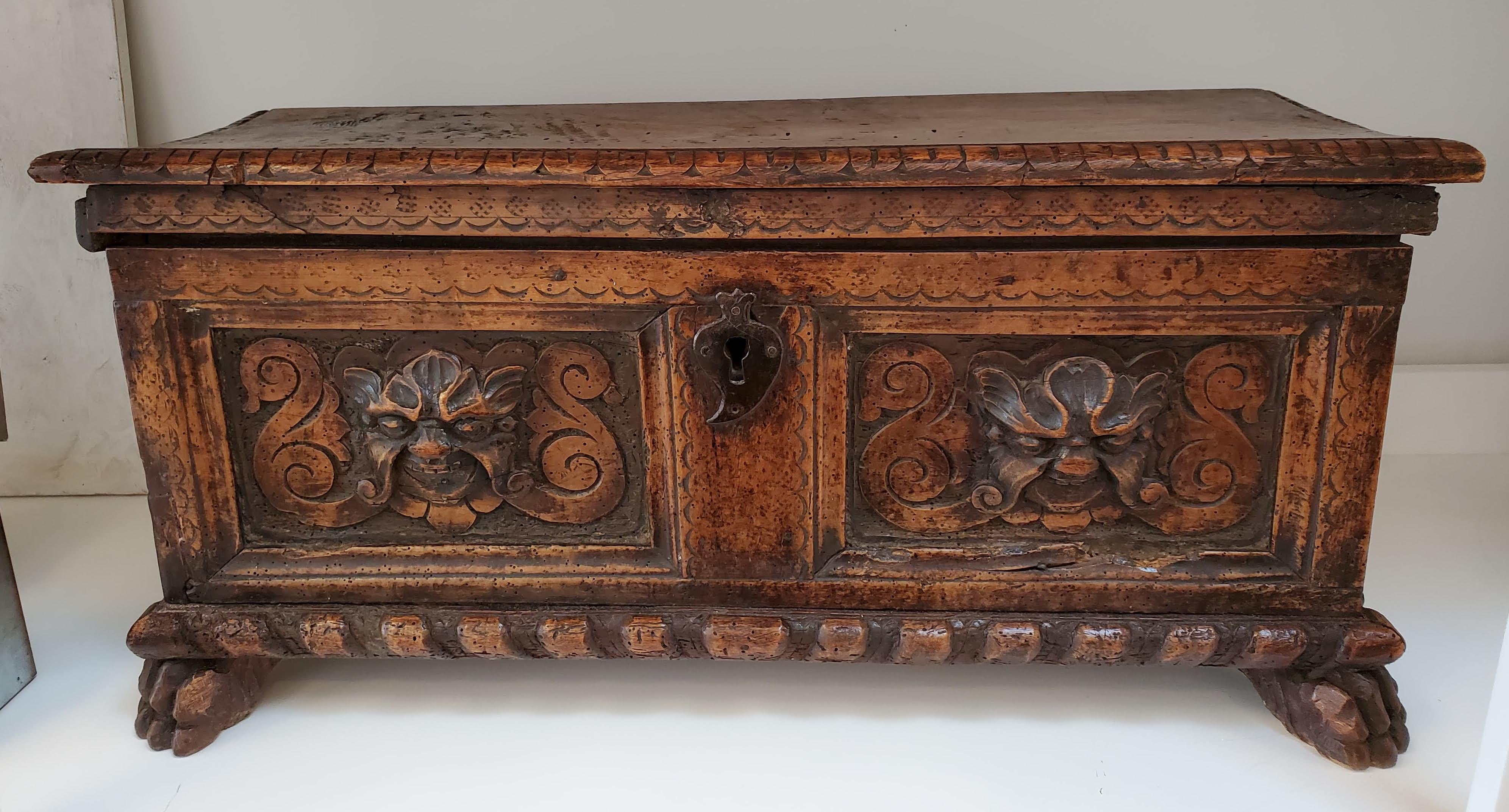 The beautiful 16th century Italian renaissance cassone or marriage box with its rare small size will make a lovely addition to your decor. With two carved panels with mask decoration above molded base and carved claw feet, this piece has many