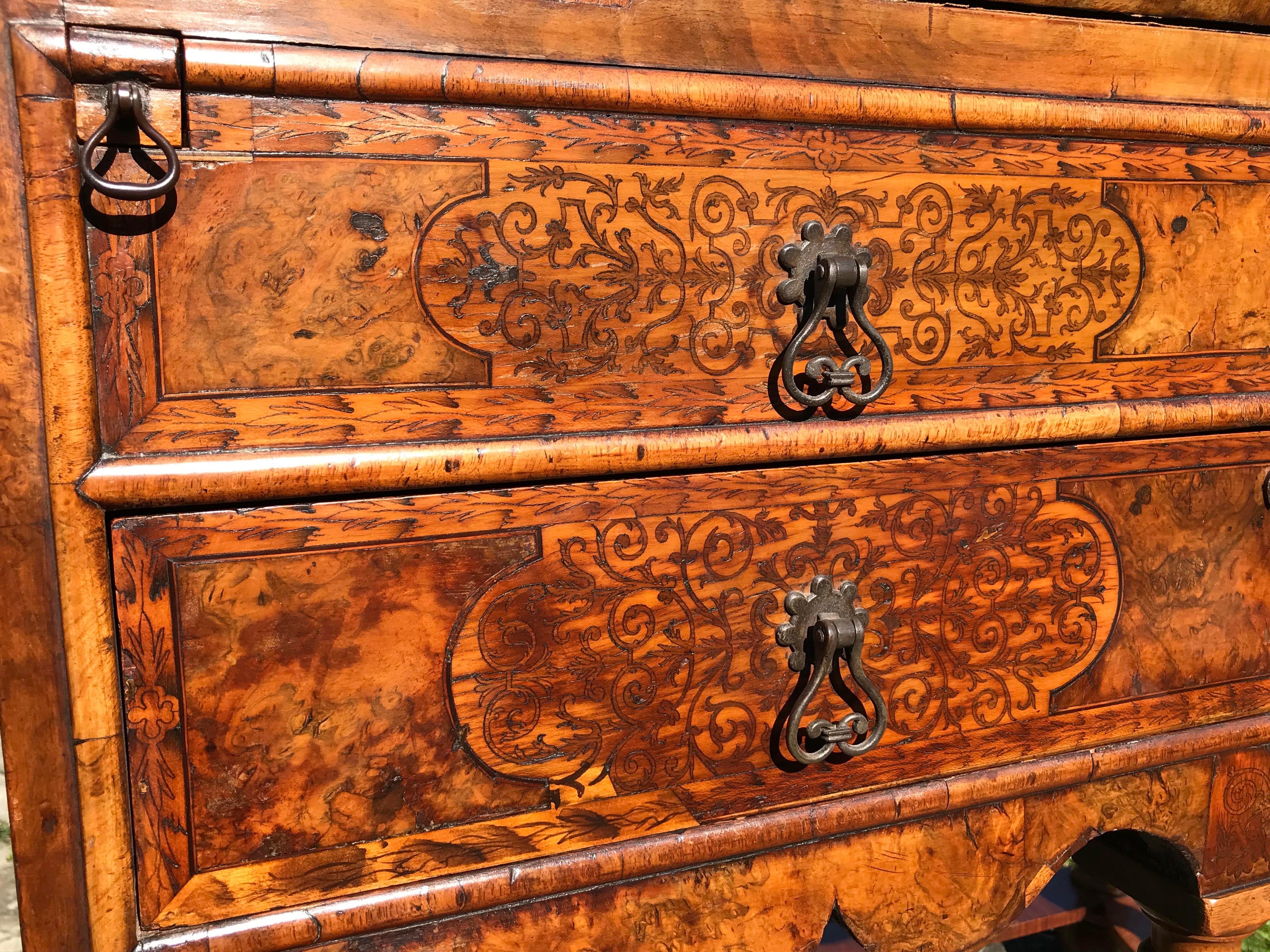 A burr walnut and marqueterie (or marquetry) bureau on stand, of lovely rich color.
Late 17th century, William & Mary period, circa 1690.

This small antique walnut and marquetry bureau is of a rare early form, a precursor to the transition taking
