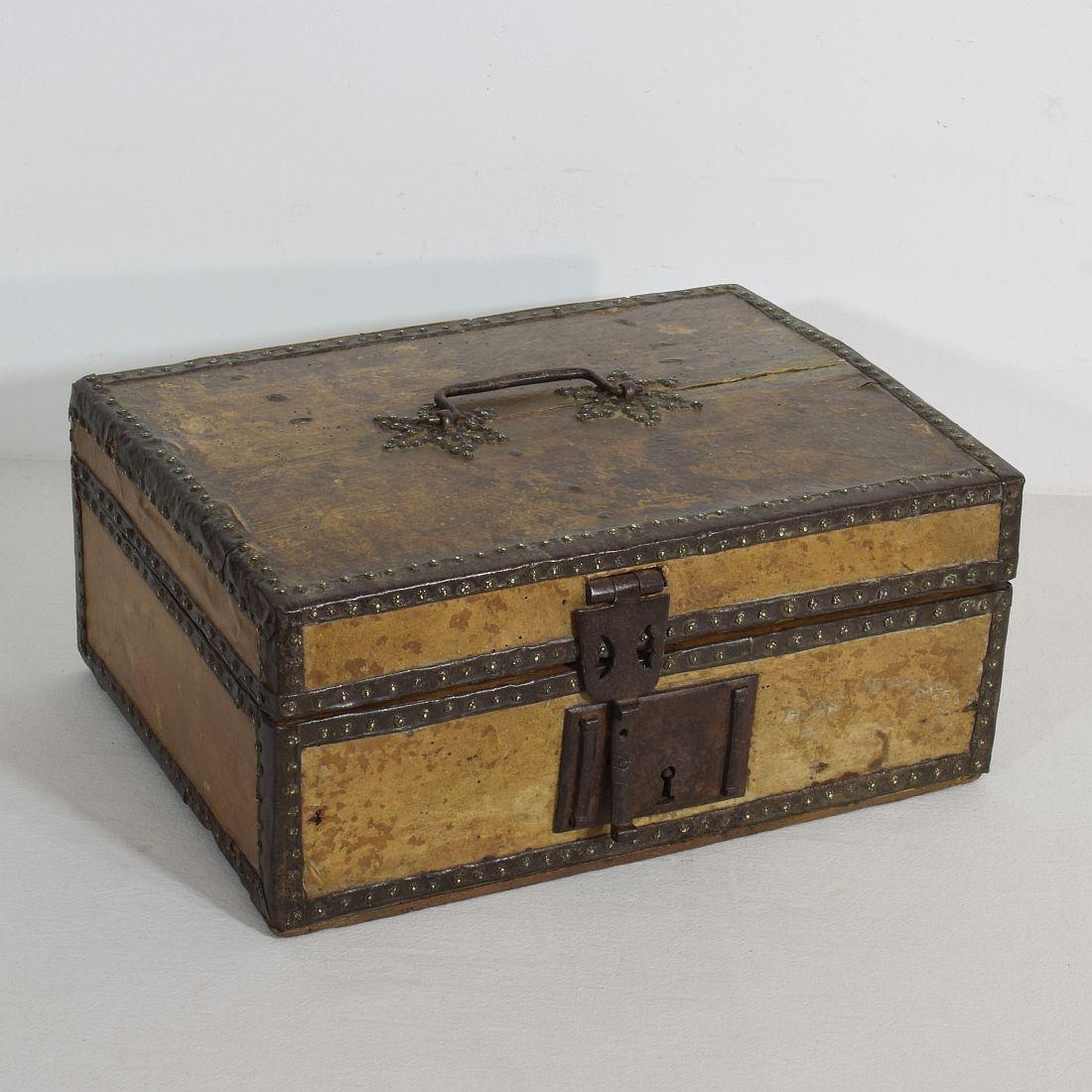 Extremely old box that is covered with leather and decorated with iron and brass. Rare find, France, circa 1600-1700
Weathered and some losses.
   
