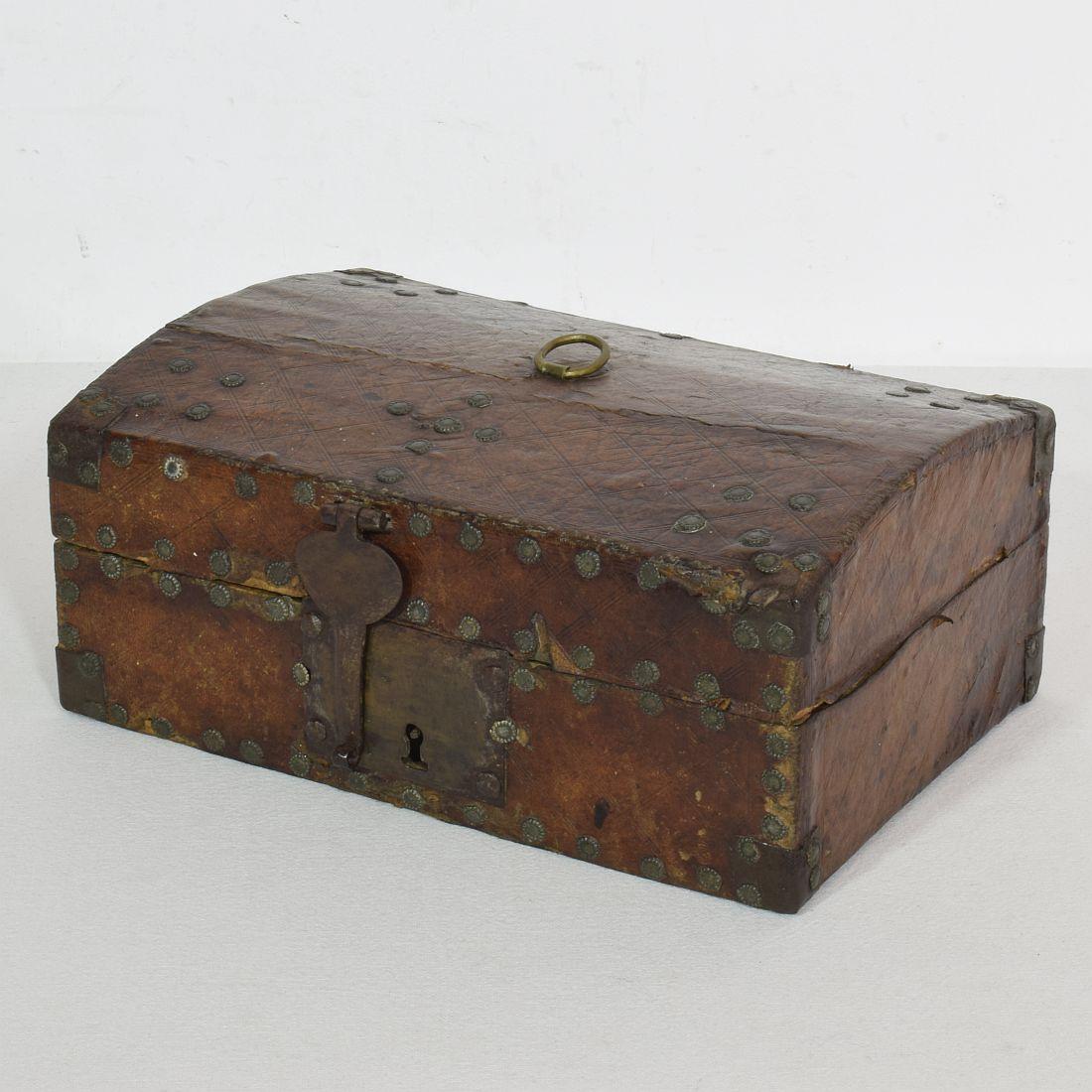 Extremely old box that is covered with leather and metal decorations. 
Rare find.
France, circa 1600-1700
Weathered and some losses.