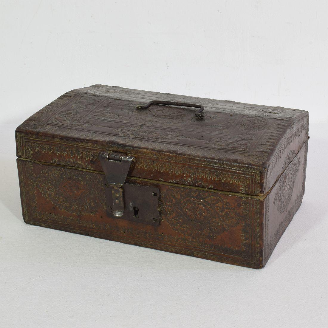 Extremely old box that is covered with leather and metal decorations. 
Rare find.
France, circa 1600-1700.
Weathered and some losses.
