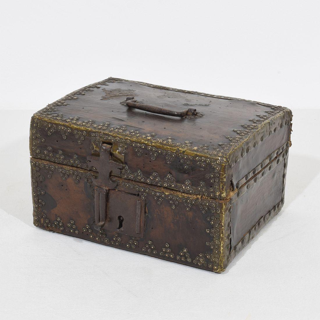 Extremely old box that is covered with leather and metal decorations. 
Rare find.
France, circa 1600-1700.
Weathered and some losses.