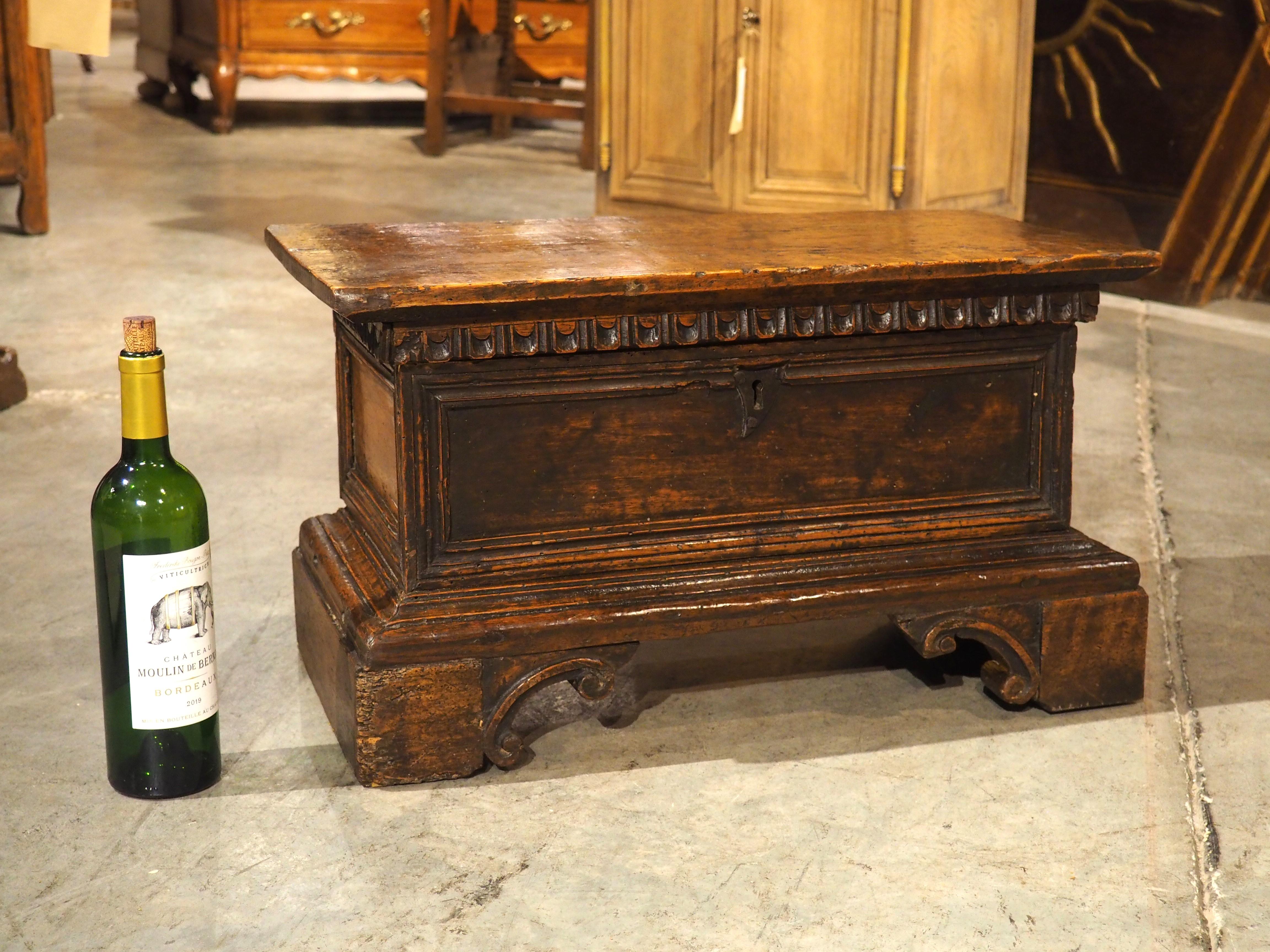 At 13 ½ inches tall and 24 inches wide, this small Italian wood cassone makes an intriguing and versatile storage piece. Hand-carved in walnut during the 1600s, the charming chest has commensurate wear that presents as a varying patina, enhancing