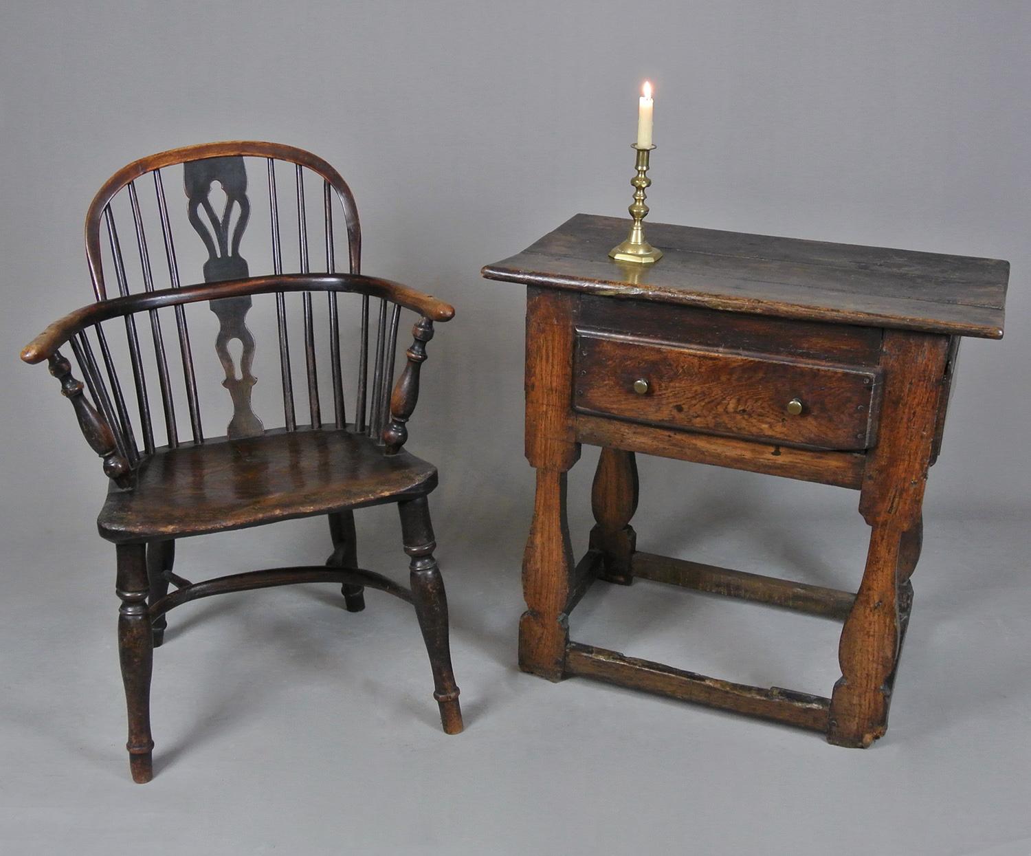A rare and beautiful small oak and elm tavern table, peg jointed throughout and with lovely shaped supports united by a box stretcher. The drawer original also with a thickly hewn oak lining and nailed up bottom. The three boarded weather top with a
