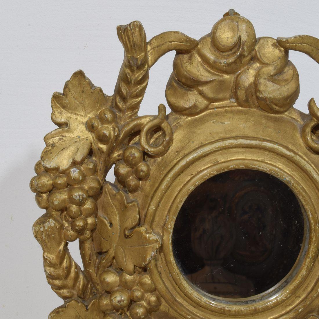 Pequeño espejo tallado a mano con uvas. Pieza única de época.
Francia, hacia 1780-1850
Envejecido, pequeñas , pequeñas pérdidas.
Las medidas incluyen la base de madera.
H:38 cm  Anch:26,5cm Prof:9cm 