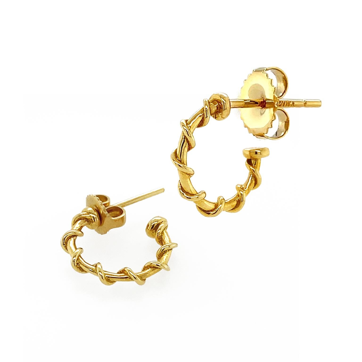 Inspired by a classic nautical theme, these 18k yellow gold hoop earrings exude warm brilliance. A 3/4 formed hoop is the base, while an 18k yellow gold strand coils similar to a nautical rope for texture. The flat base at the end of the hoop