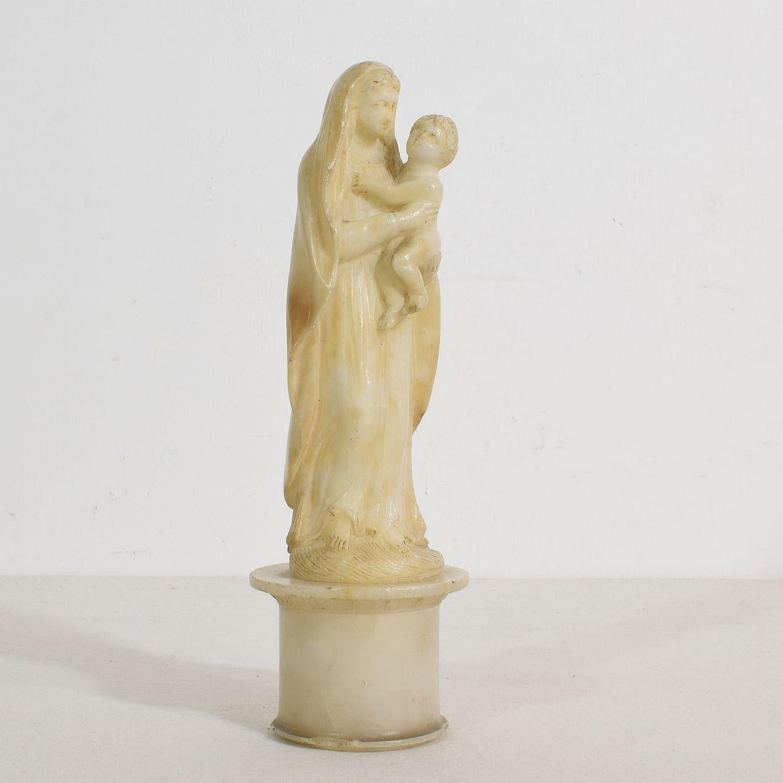 Beautiful small carved alabaster Madonna with child, France, circa 1780-1850.
Weathered and some minor losses.