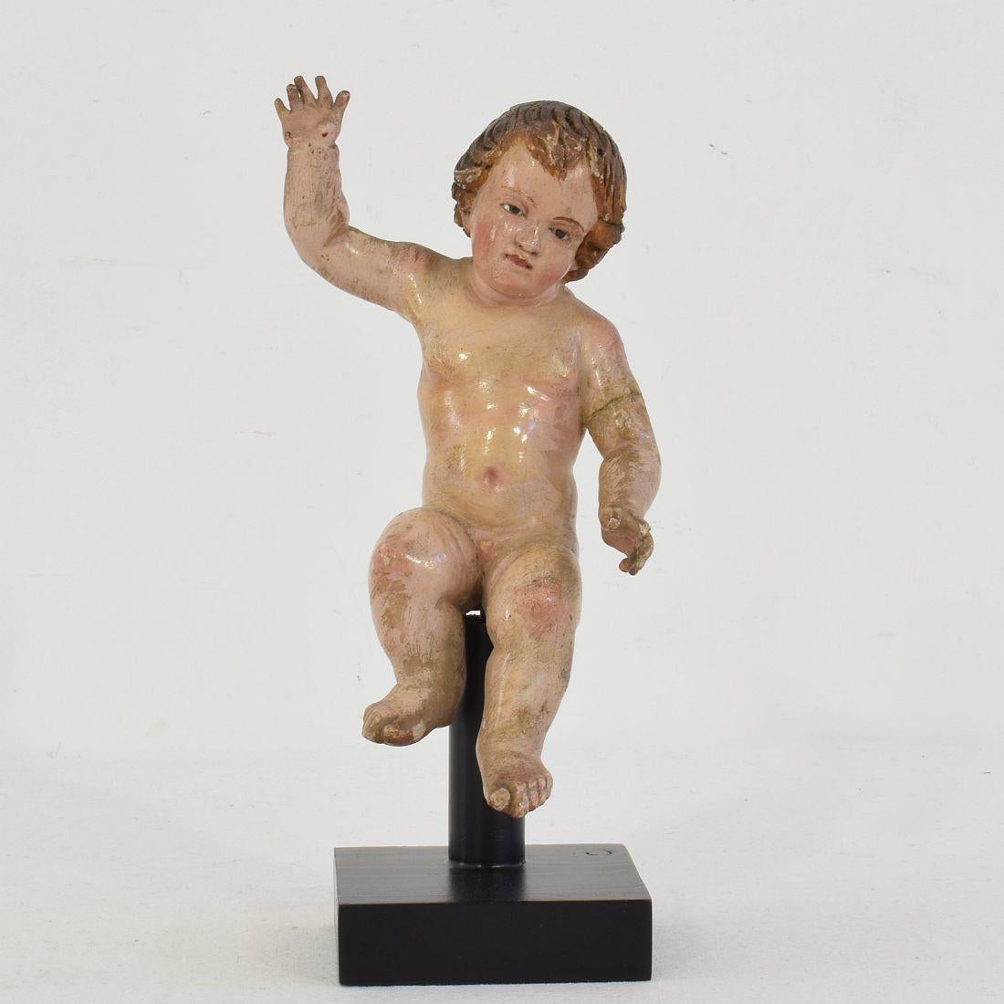 Beautiful small baby Jesus/ Angel with glass eyes and its original color,
Spain, circa 1750. Weathered, small losses and old repairs. Measurement with the base.